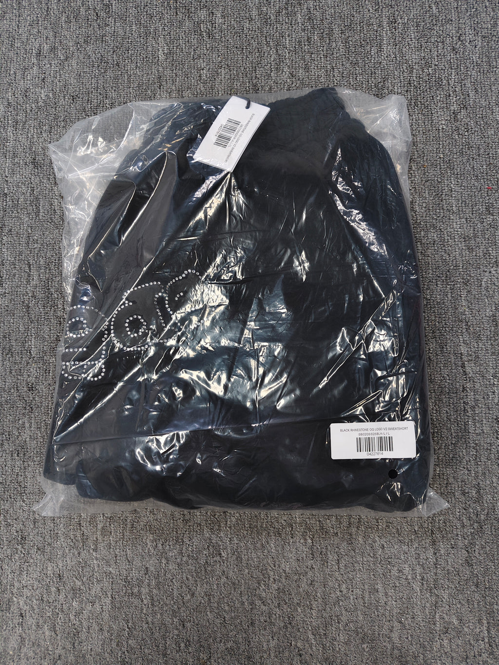 black Sp5der shorts feature a rhinestone-embellished logo and a spider web graphic