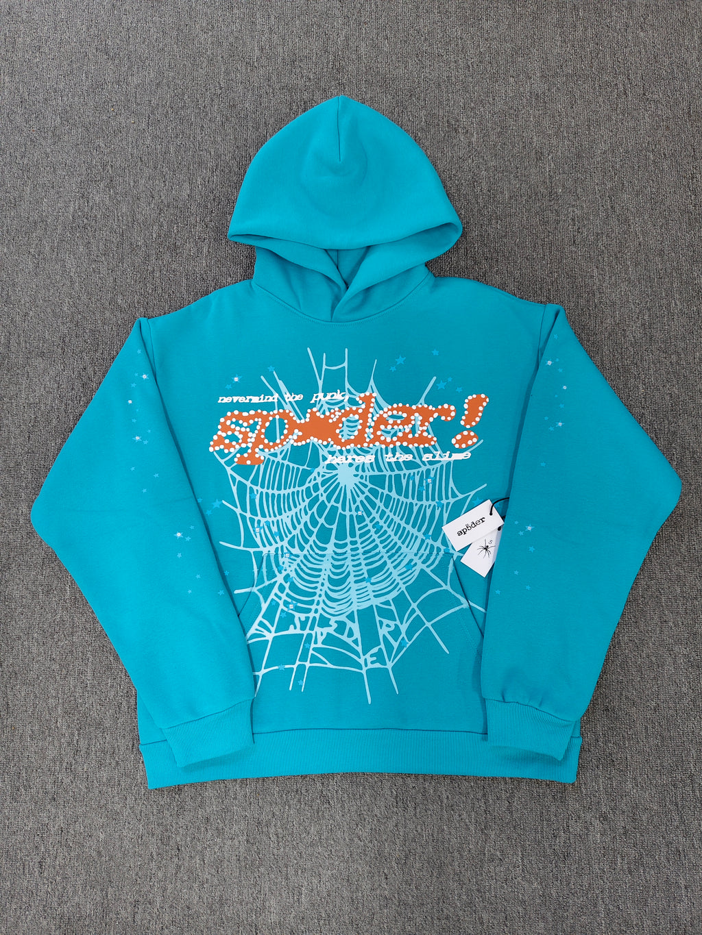 a Sp5der Punk V2 Hoodie in the Cyan colorway, featuring a prominent rhinestone graphic and spider web motif