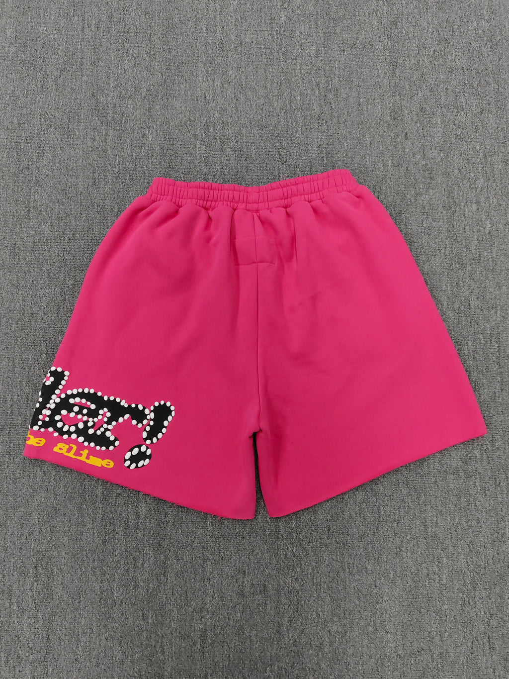 pink shorts Sp5der "Punk V2" collection, featuring rhinestone branding and scattered star graphics