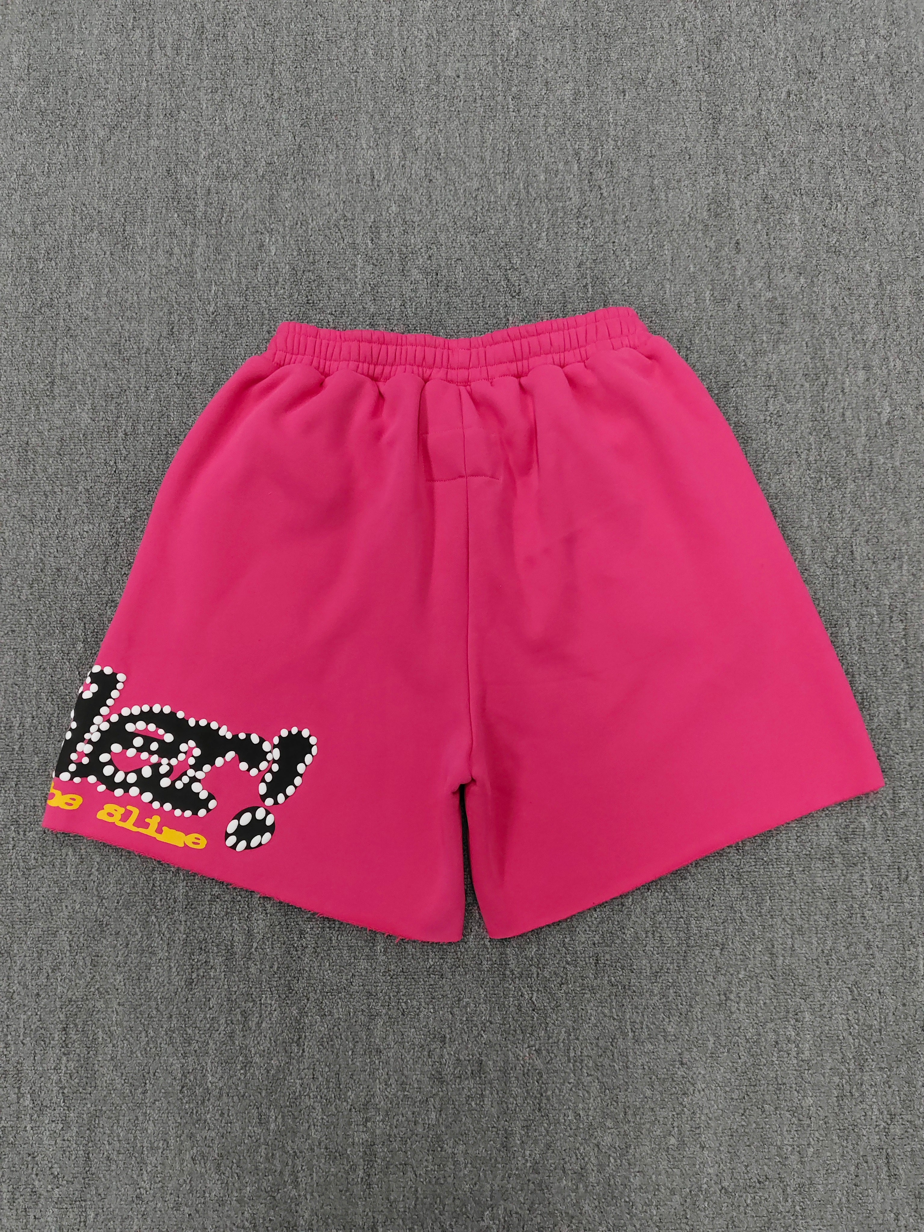 pink shorts Sp5der "Punk V2" collection, featuring rhinestone branding and scattered star graphics
