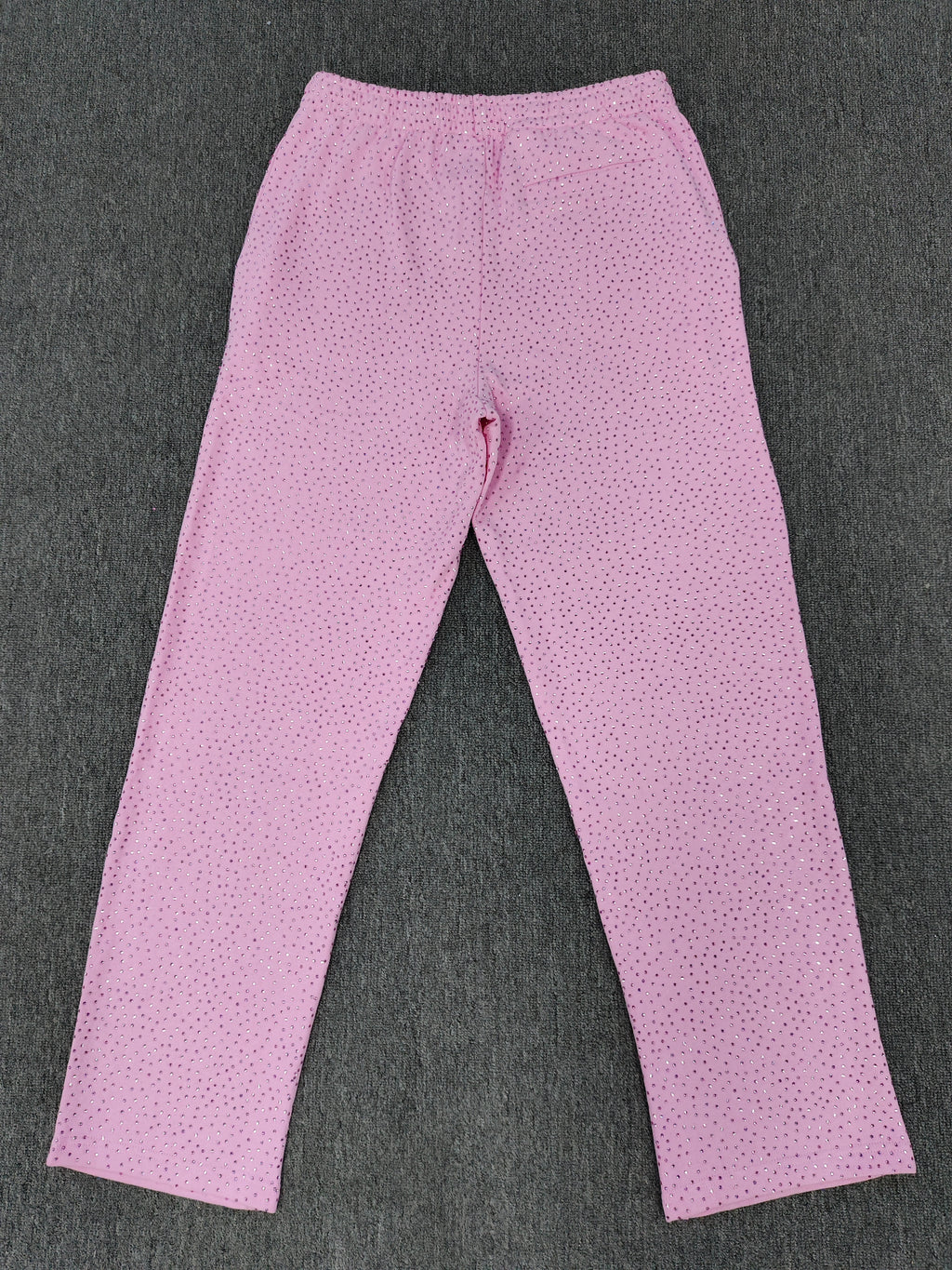 pink Sp5der sweatpants feature an all-over tonal rhinestone application and a SP5DER logo printed across the crotch