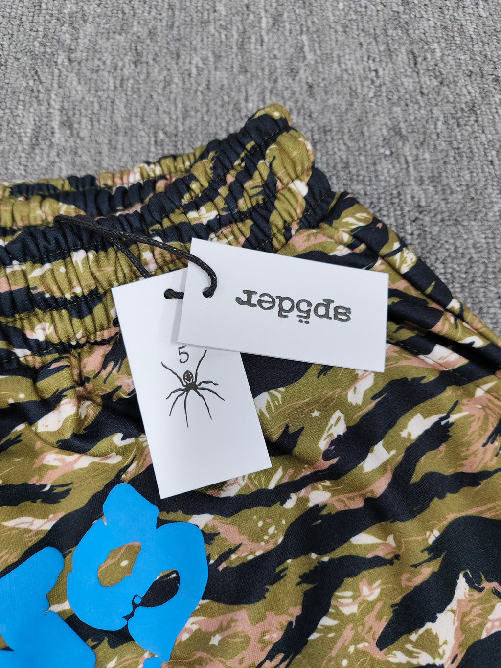 Sp5der OG Web V2 Tiger Camo Sweatshorts featuring a prominent tiger stripe pattern and an elasticated waistband