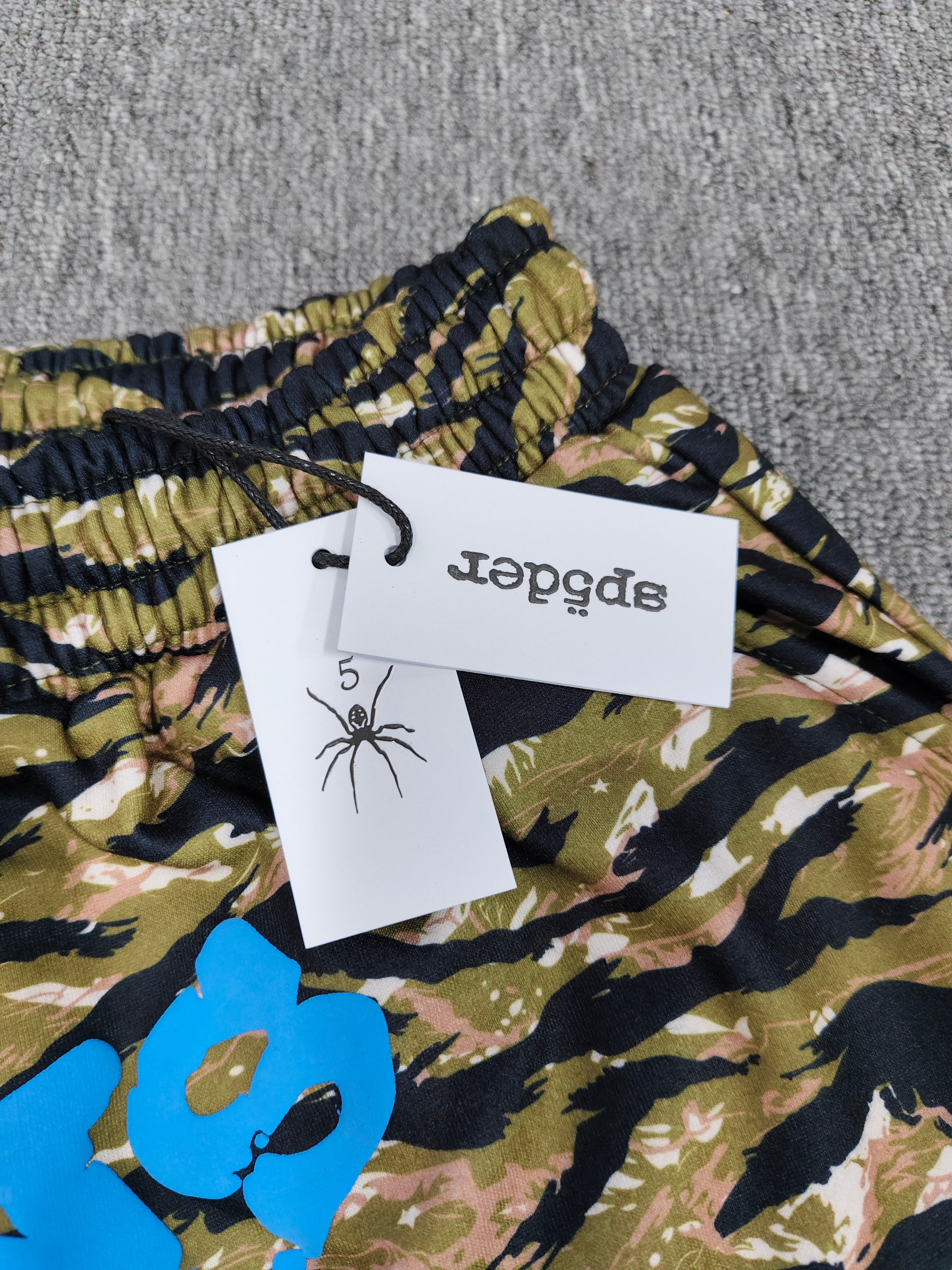 Sp5der OG Web V2 Tiger Camo Sweatshorts featuring a prominent tiger stripe pattern and an elasticated waistband