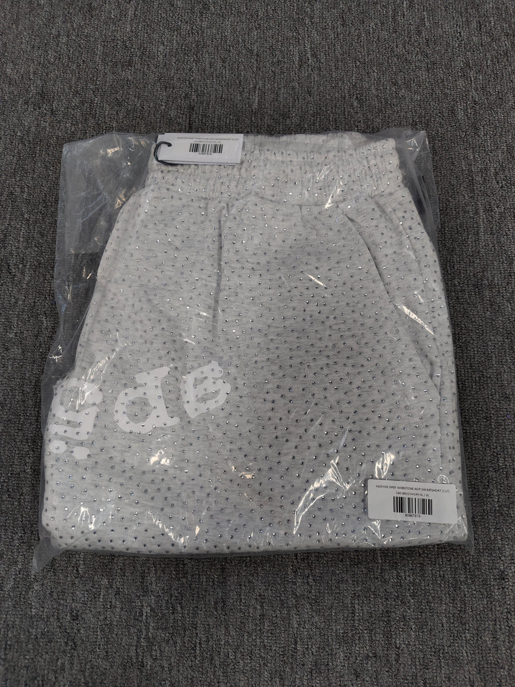 Sp5der VVS sweatshorts in heather grey feature a rhinestone logo and raw edge hemlines