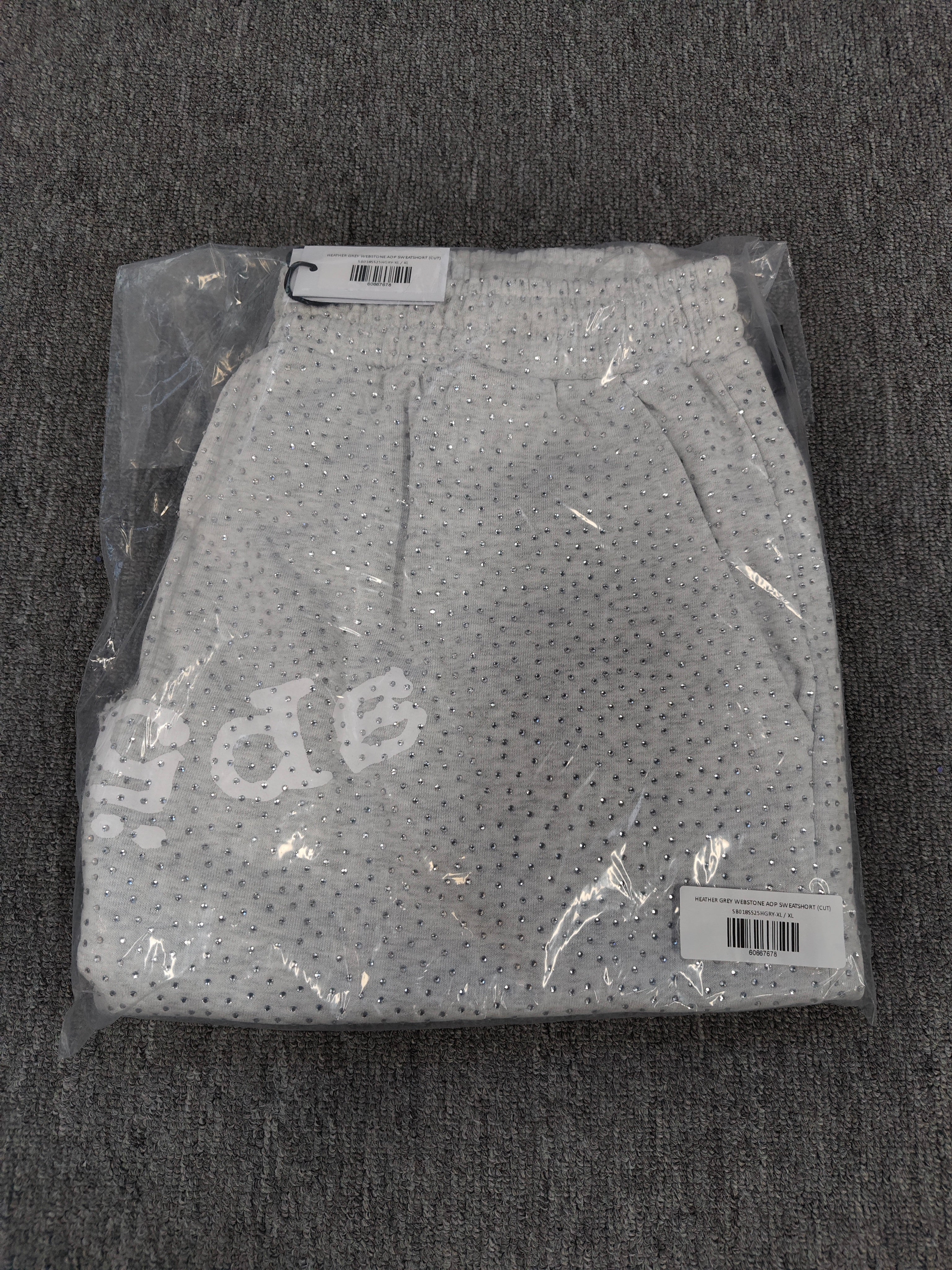Sp5der VVS sweatshorts in heather grey feature a rhinestone logo and raw edge hemlines