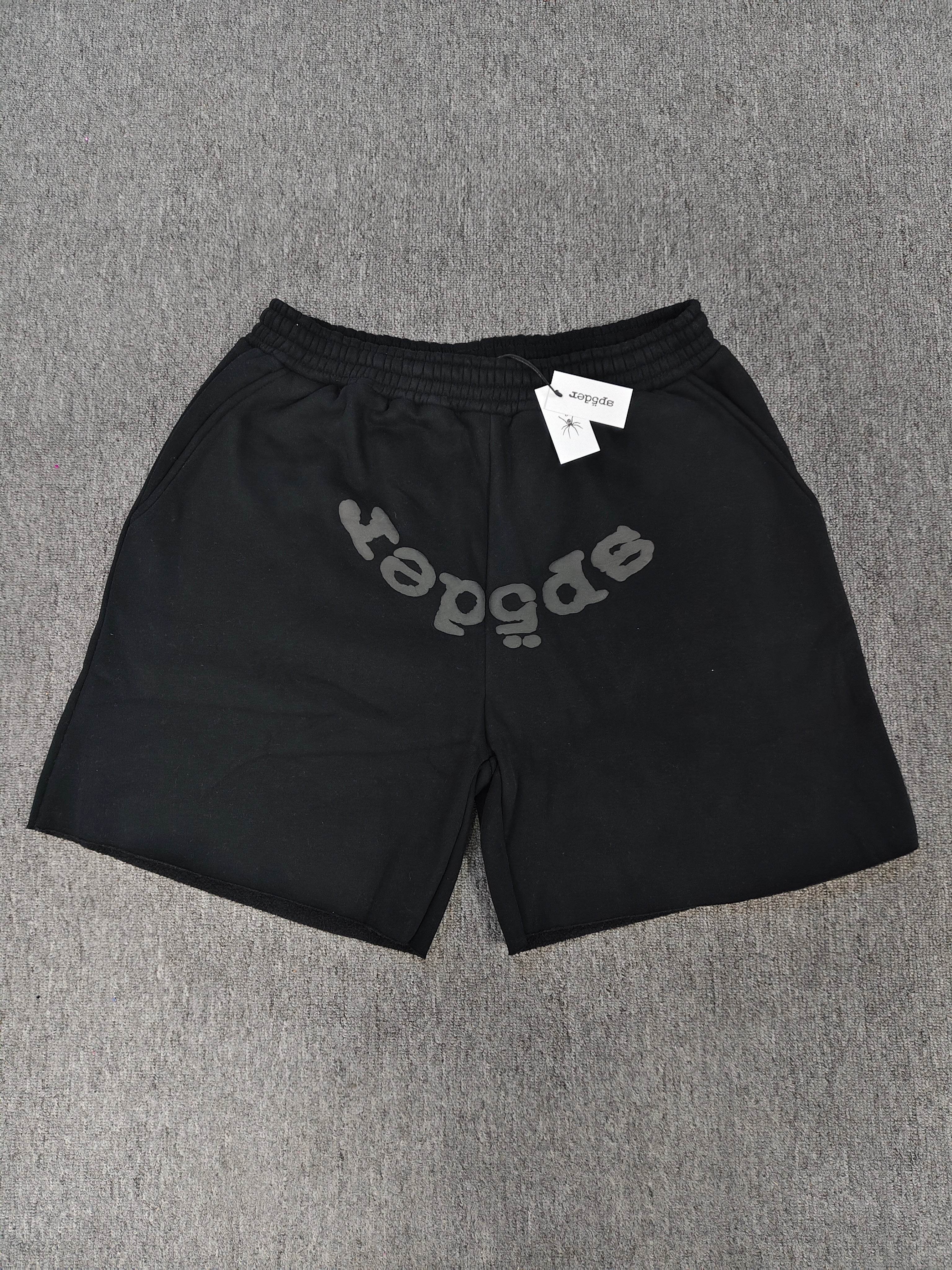 Sp5der OG Web V2 Phantom shorts in black feature a prominent rhinestone logo