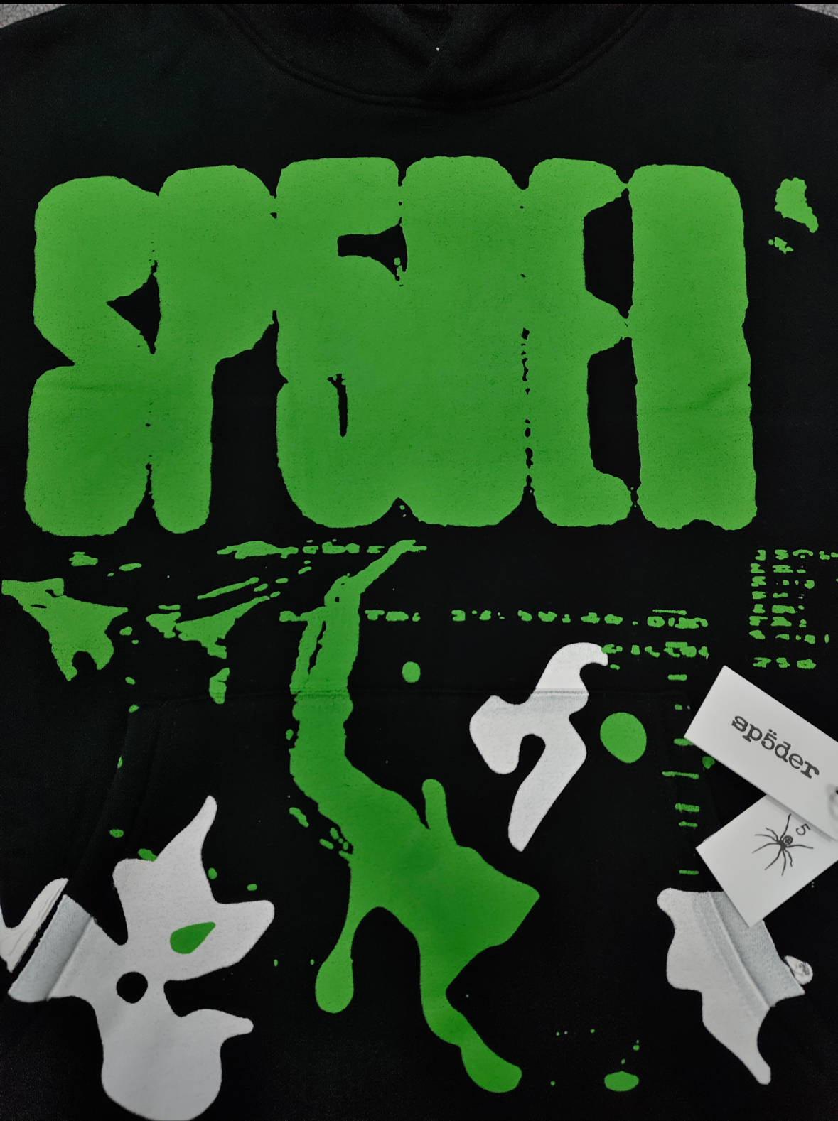 black Sp5der X-Ray Hoodie featuring prominent neon green slime-style graphics