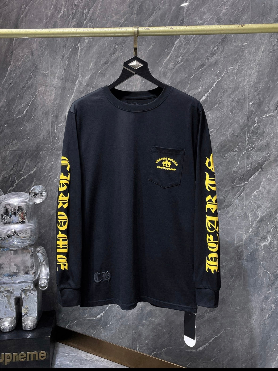 a Chrome Hearts Hollywood Triple Cross Long Sleeve T-Shirt featuring a prominent graphic on the back.