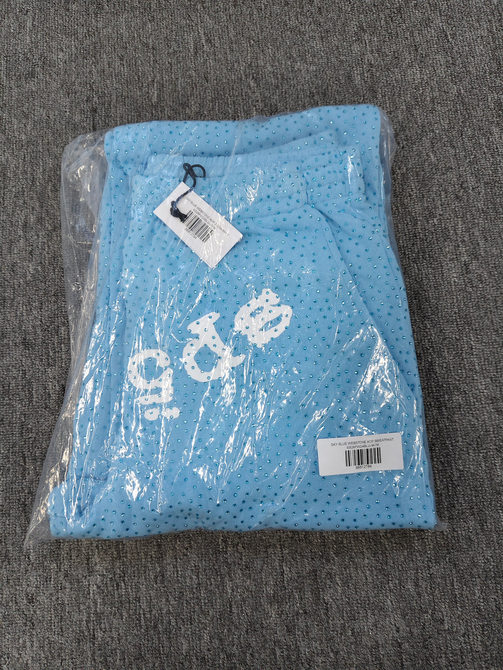 sky blue Sp5der Classic Sweatpants feature an all-over rhinestone design and the brand's logo in a sparkling applique