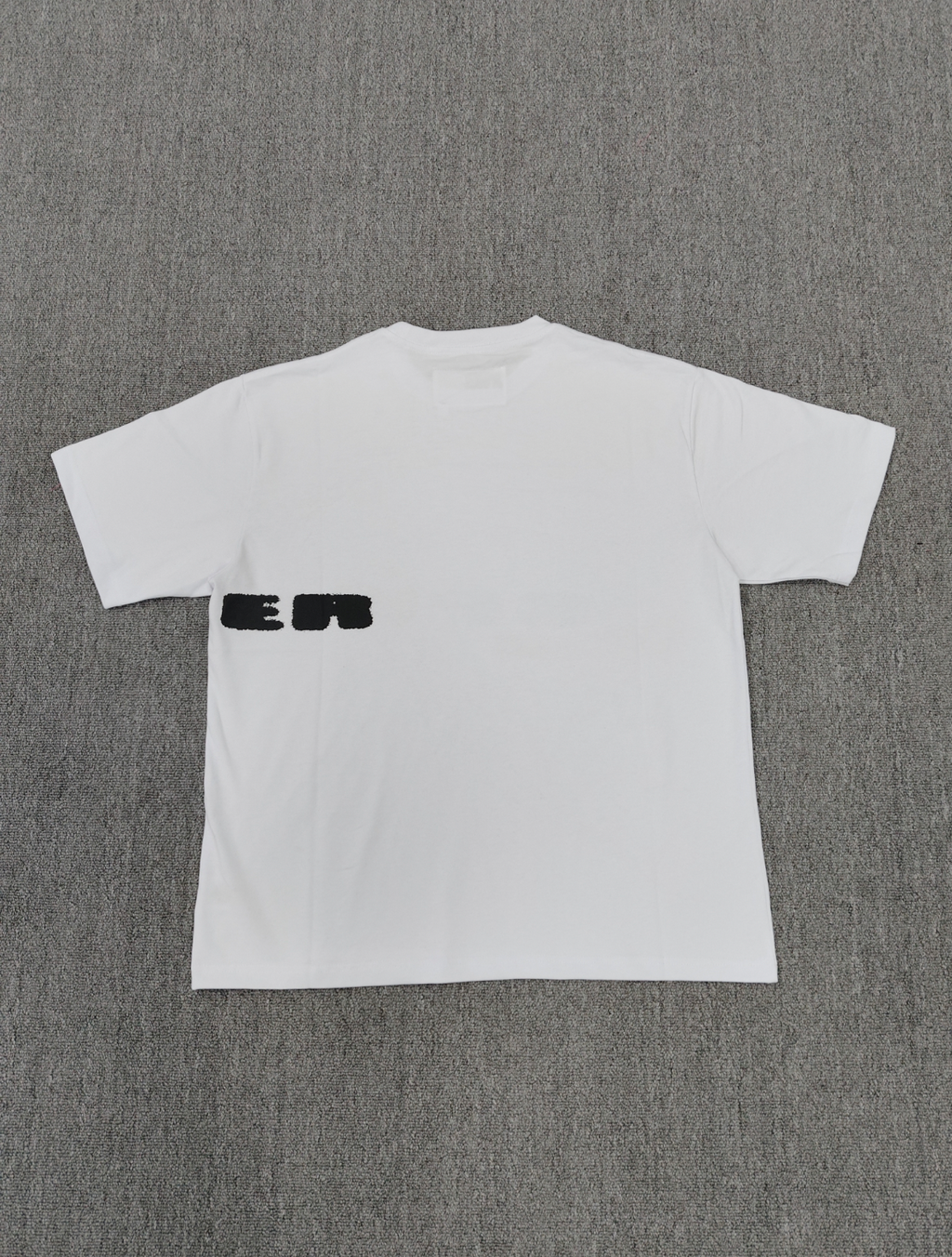 Sp5der Spinner T-Shirt in white, featuring a distinctive red web graphic and black lettering