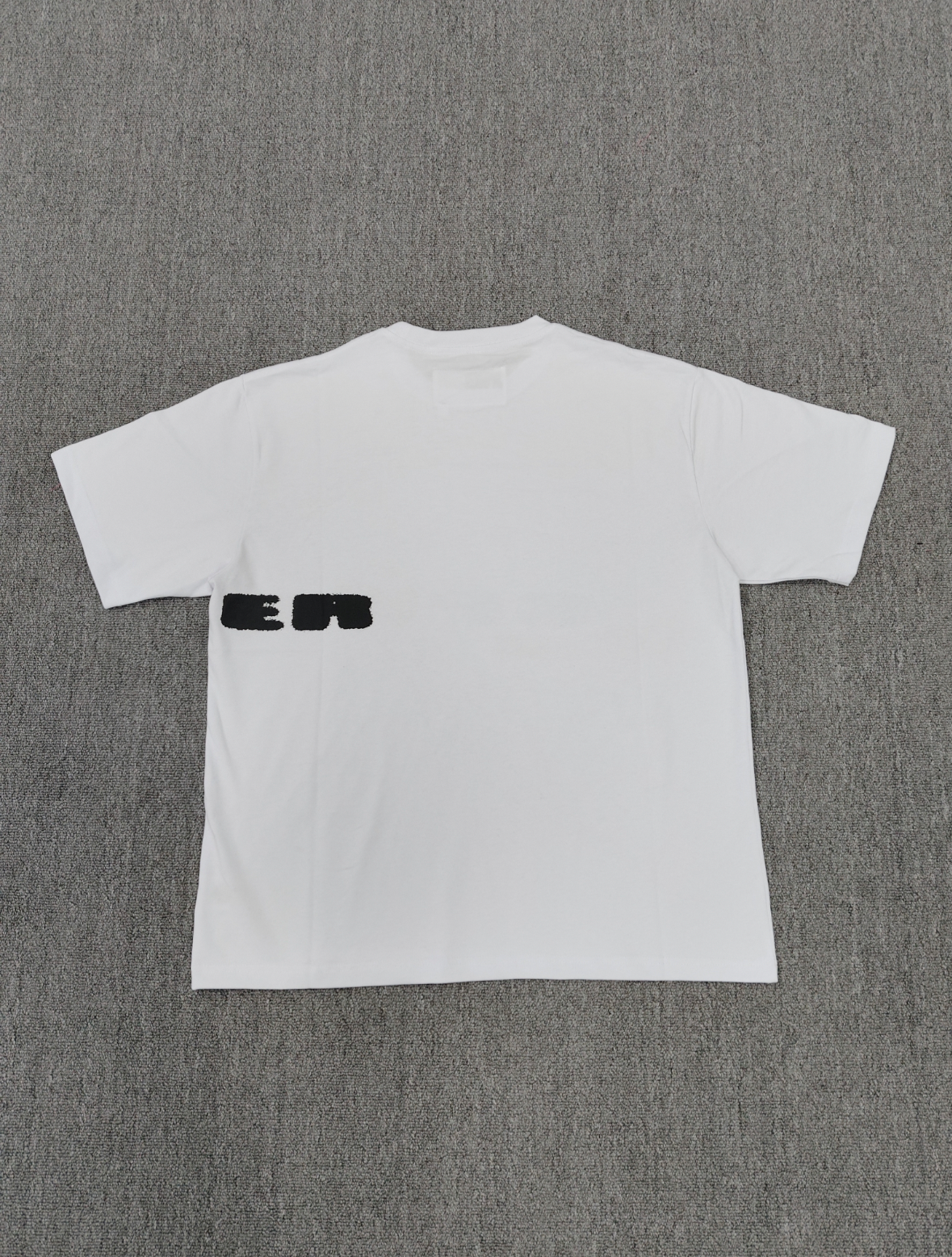 Sp5der Spinner T-Shirt in white, featuring a distinctive red web graphic and black lettering