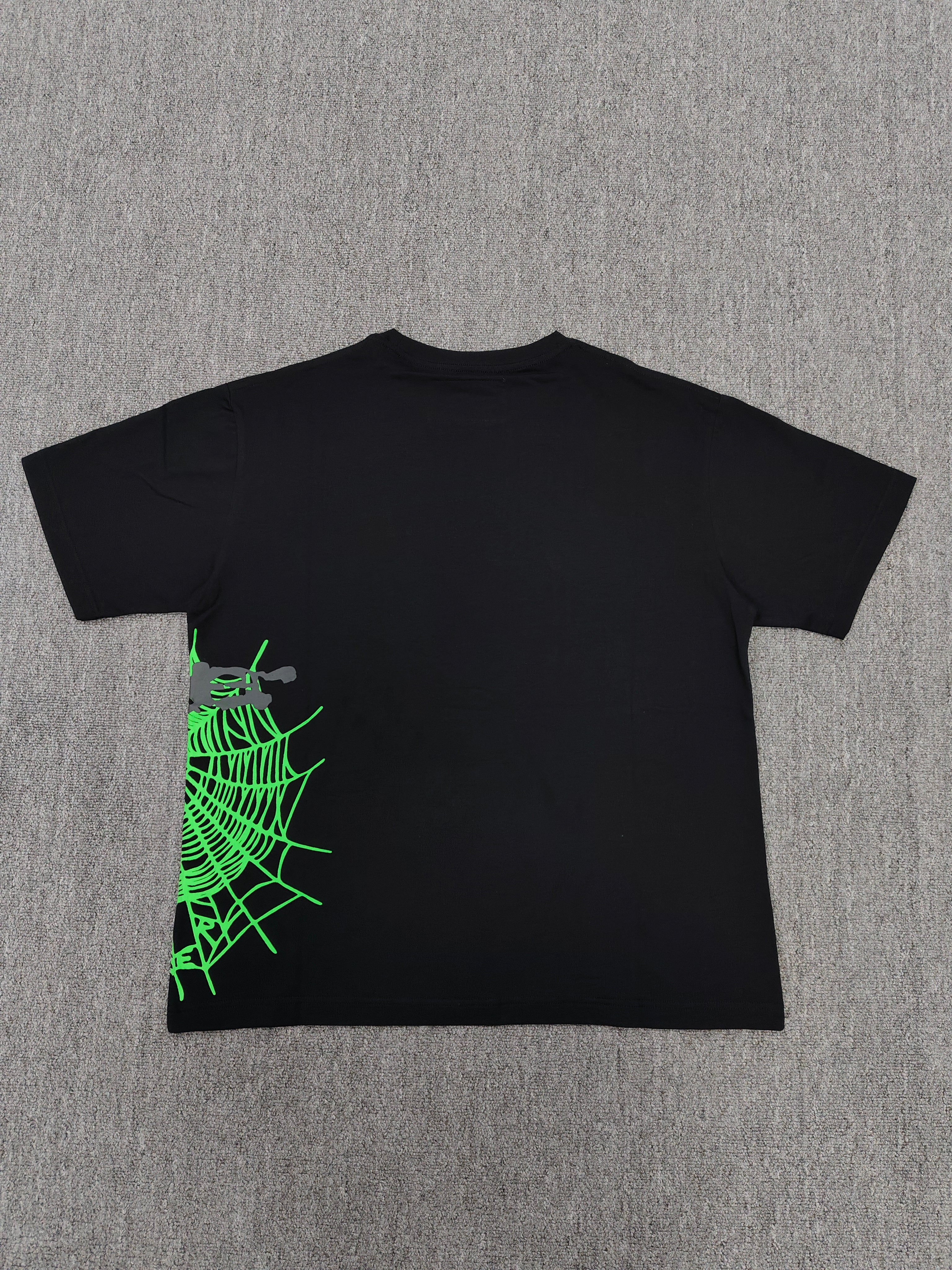 a Sp5der Heavy Web T-shirt in black featuring a prominent neon green web graphic and scattered star print