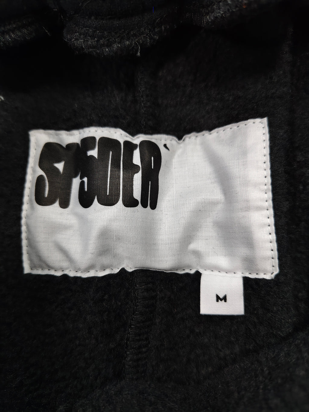 black Sp5der OG Web Logo sweatshorts featuring a prominent white puff-print logo and scattered star graphics
