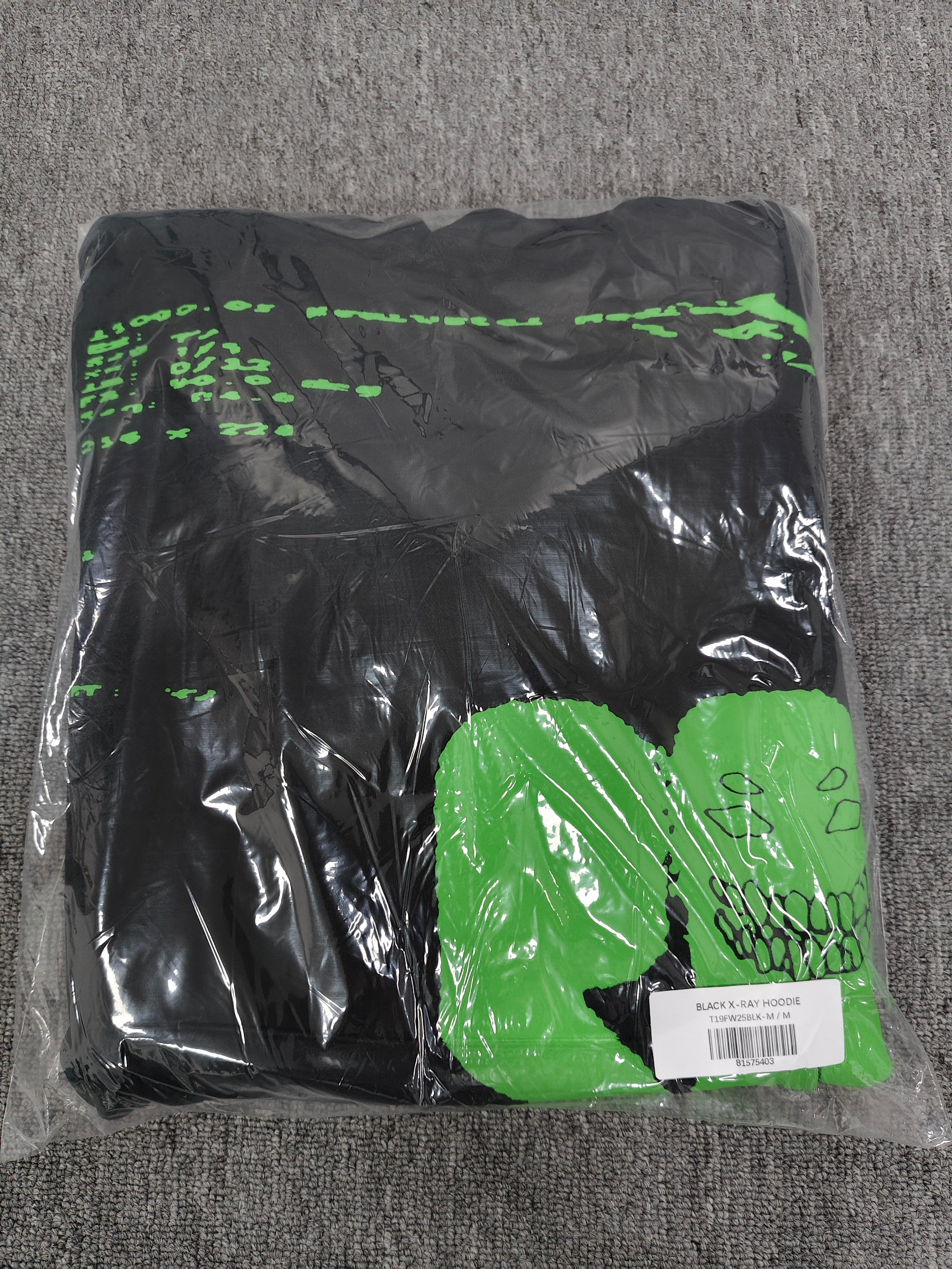 Sp5der Black Neon Green Skull Graphic Hoodie, featuring bold neon green graphics on a black base