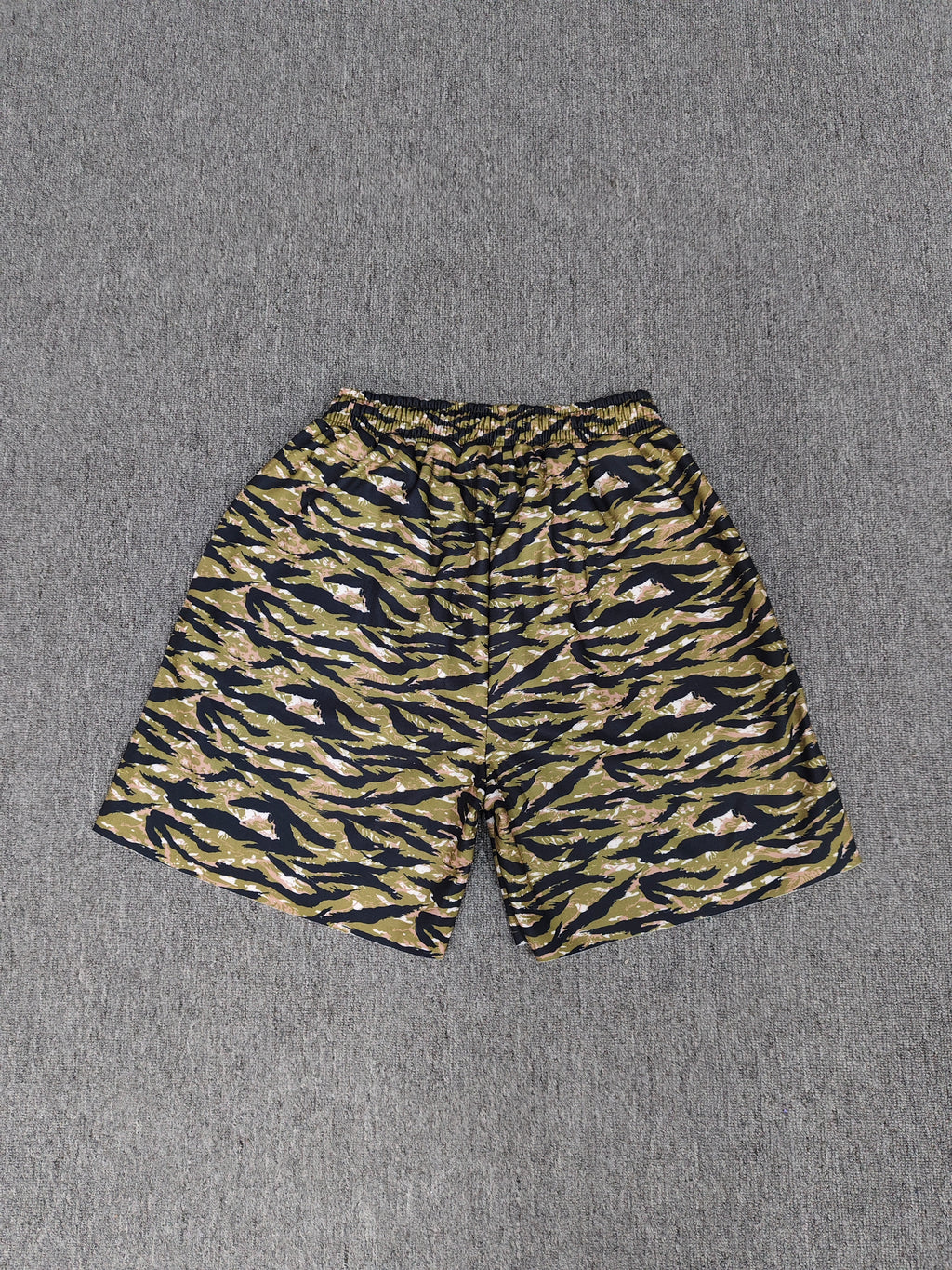 Sp5der OG Web V2 Tiger Camo Sweatshorts featuring a prominent tiger stripe pattern and an elasticated waistband