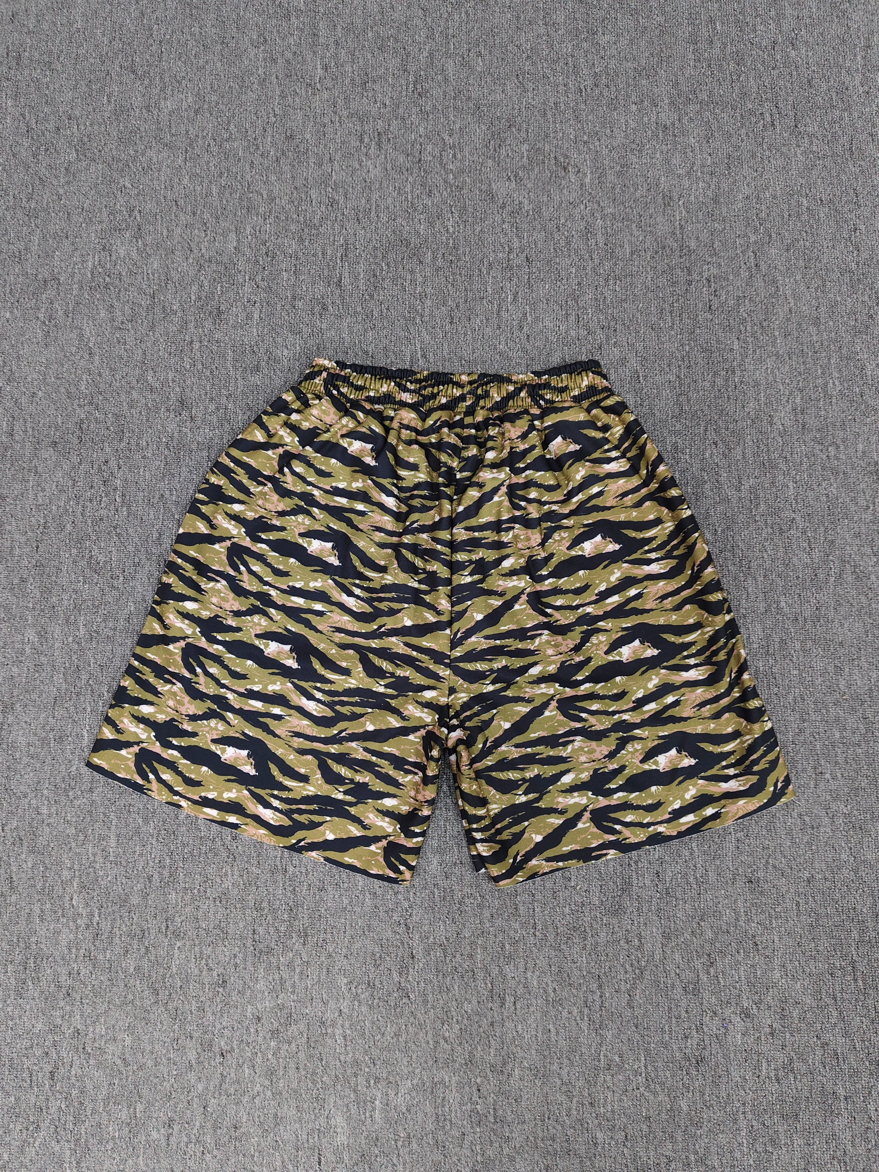 Sp5der OG Web V2 Tiger Camo Sweatshorts featuring a prominent tiger stripe pattern and an elasticated waistband