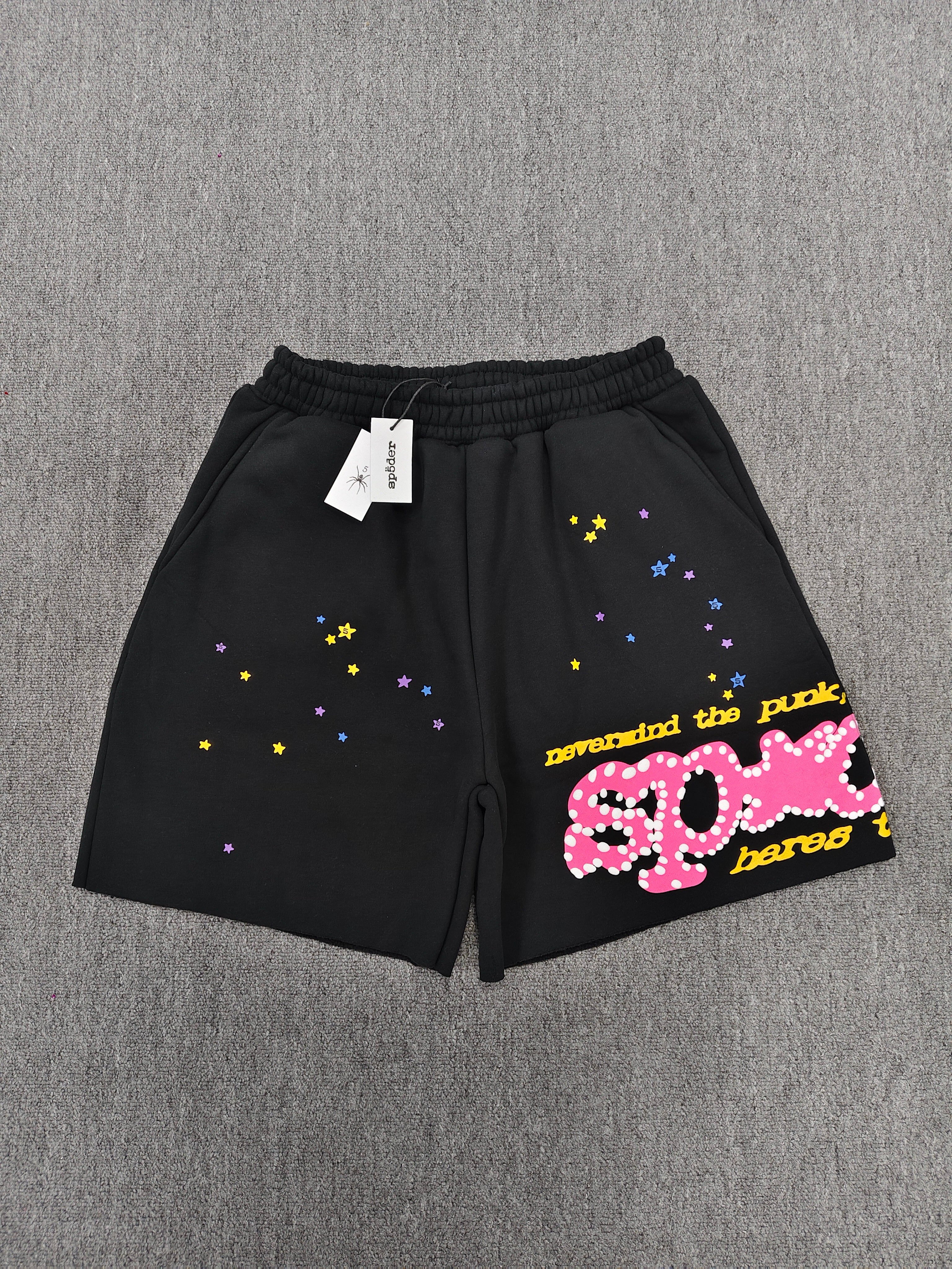 Sp5der Punk V2 shorts in black, featuring a vibrant pink logo and scattered colorful stars