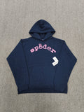 a Sp5der Worldwide navy blue hoodie featuring a pink rhinestone logo