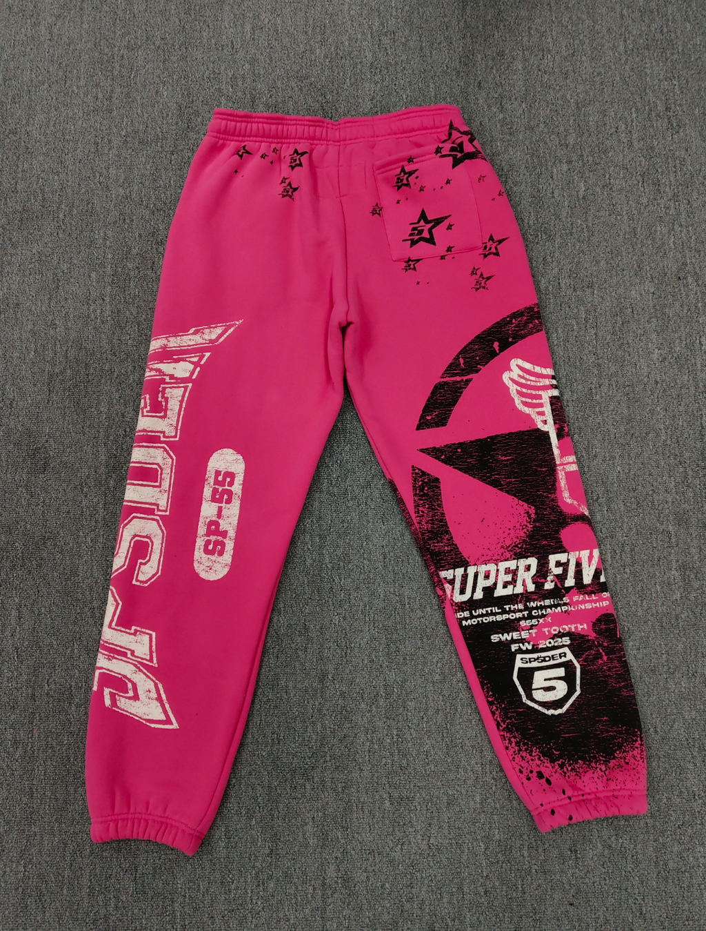 SP5DER Stencil Sweatpants in pink, featuring a large black star graphic on the left leg