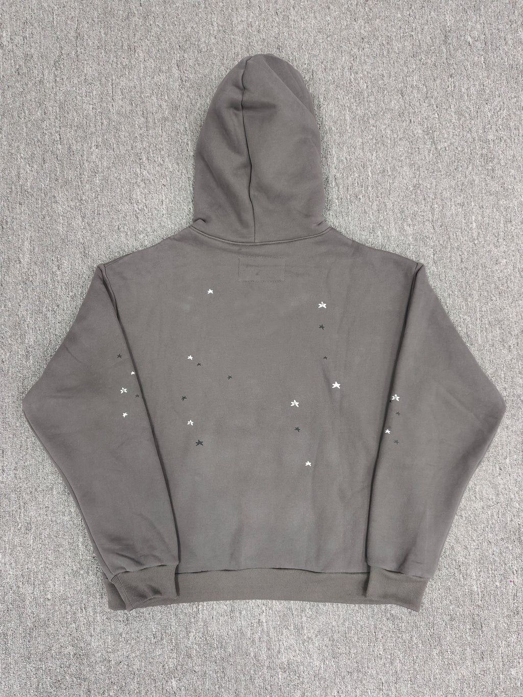 slate grey Sp5der Splat Punk Hoodie features a prominent red spider-web graphic with white star accents