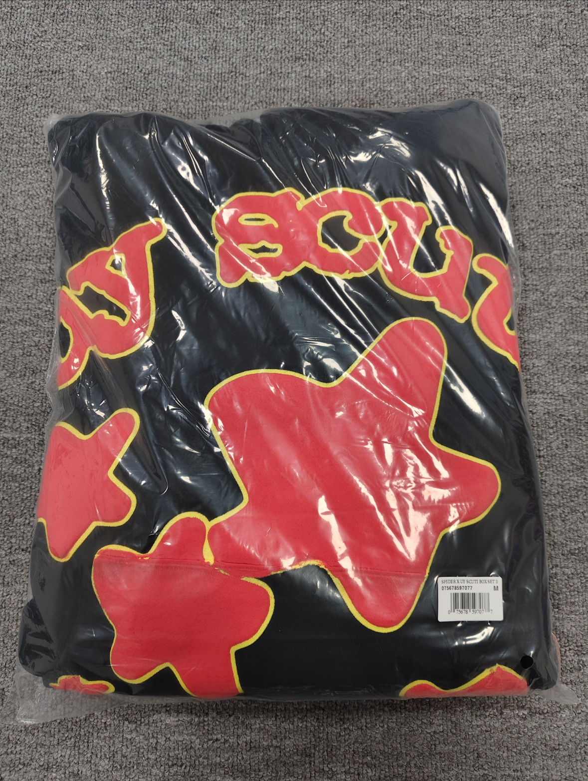 Sp5der x UY SCUTI Hoodie in black features prominent red star graphics