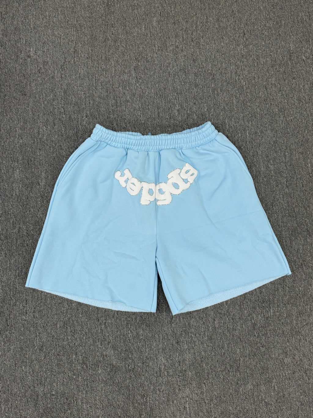 Sp5der OG Web Sweatshorts in Sky Blue, featuring the brand's signature webbed logo graphic on the front