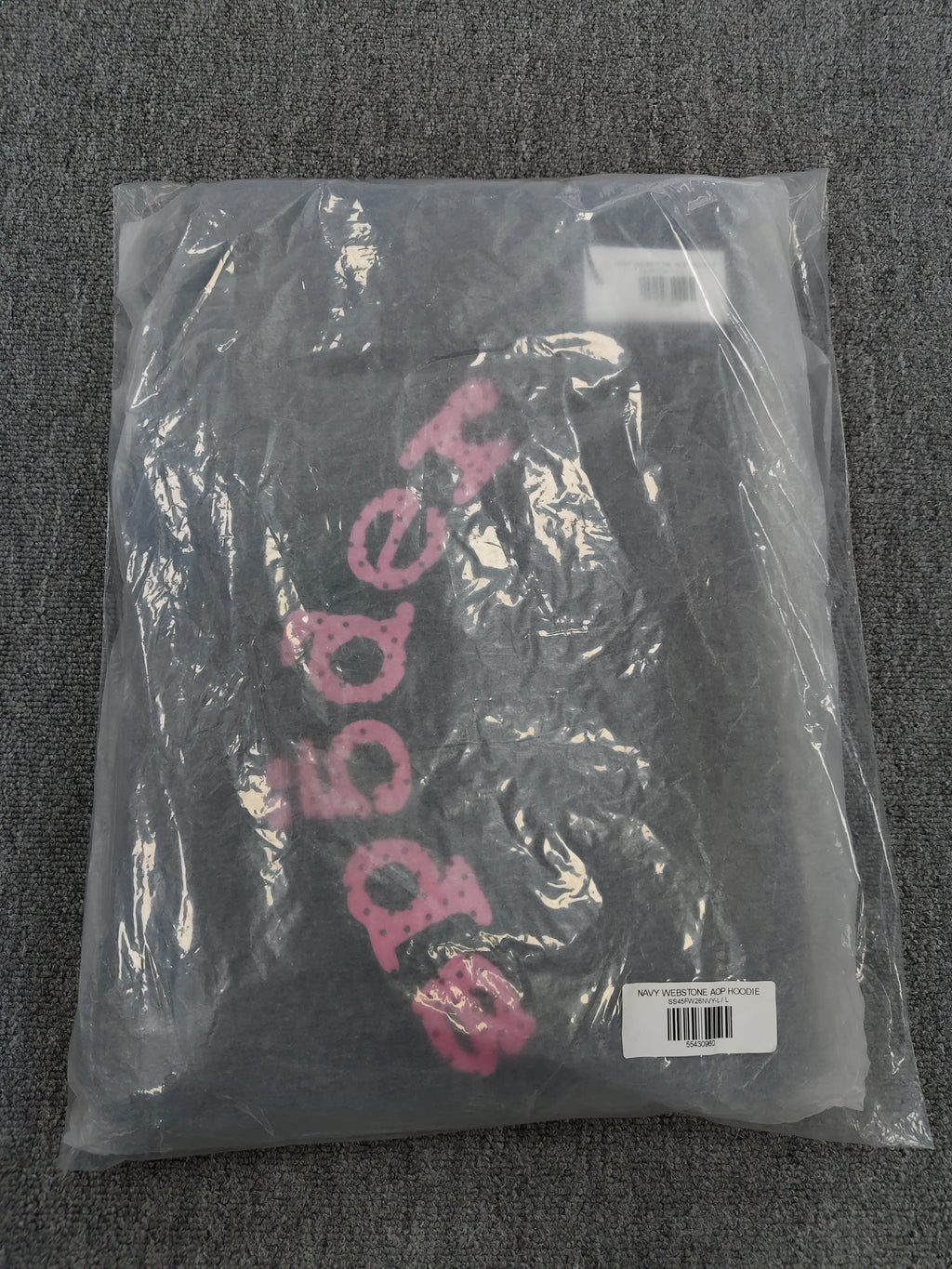 a Sp5der Worldwide navy blue hoodie featuring a pink rhinestone logo