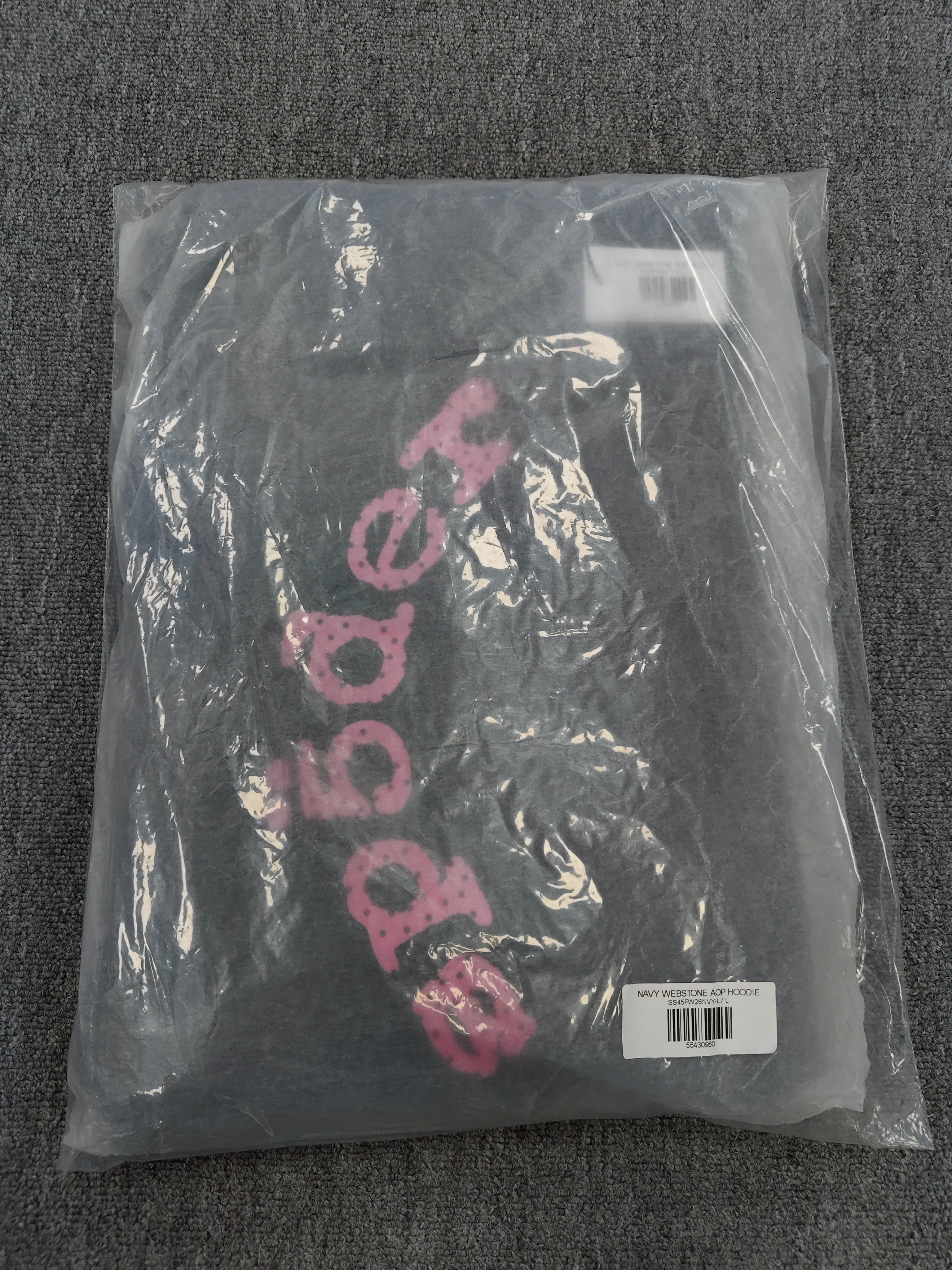 a Sp5der Worldwide navy blue hoodie featuring a pink rhinestone logo