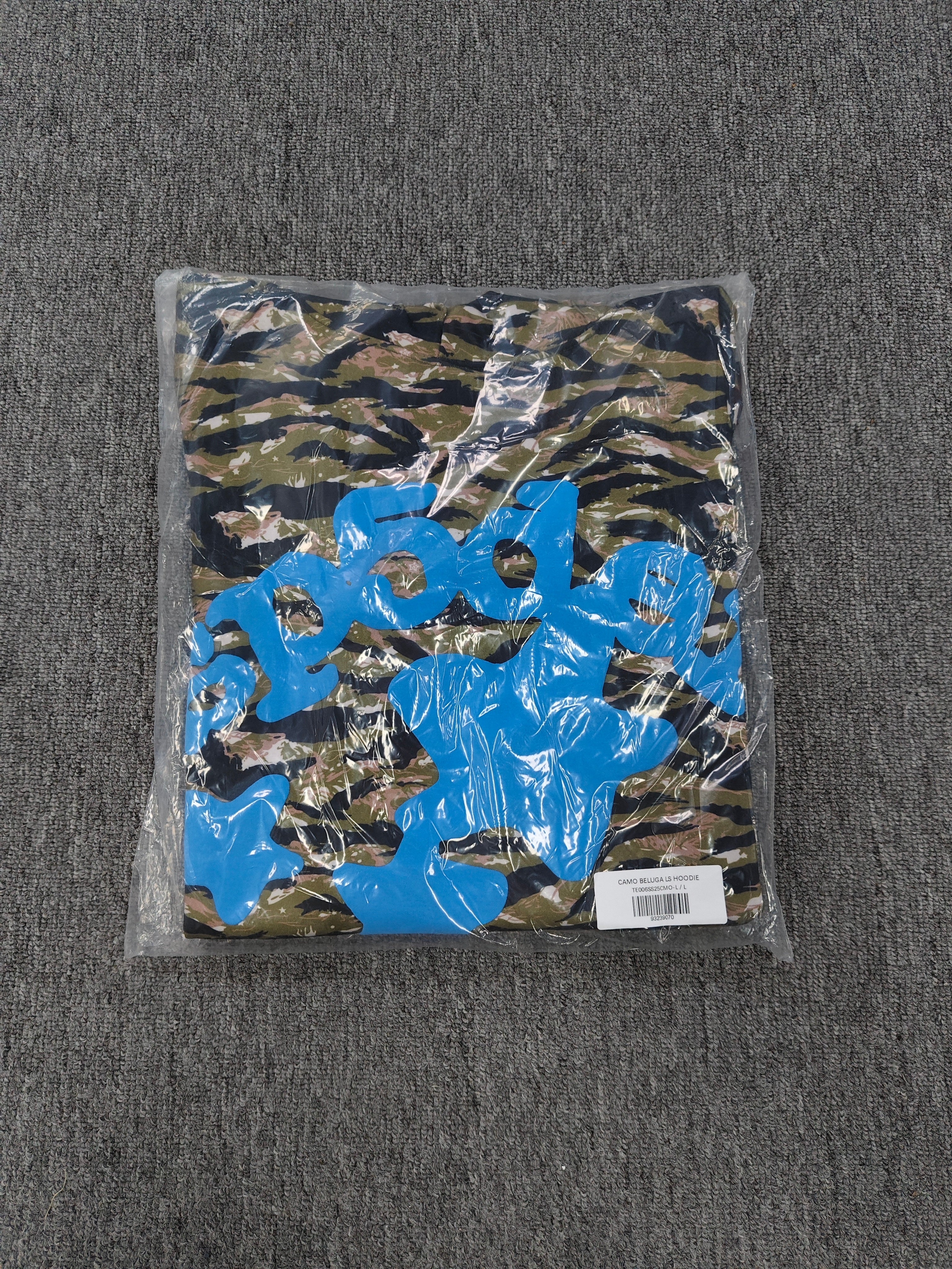 Sp5der Beluga hoodie features a distinct tiger camo pattern and vibrant blue star graphics