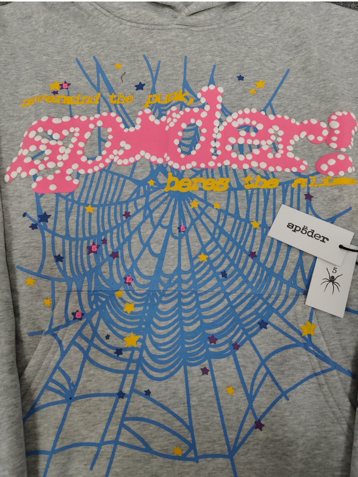 grey Sp5der hoodie features a prominent pink rhinestone graphic and a blue spiderweb design