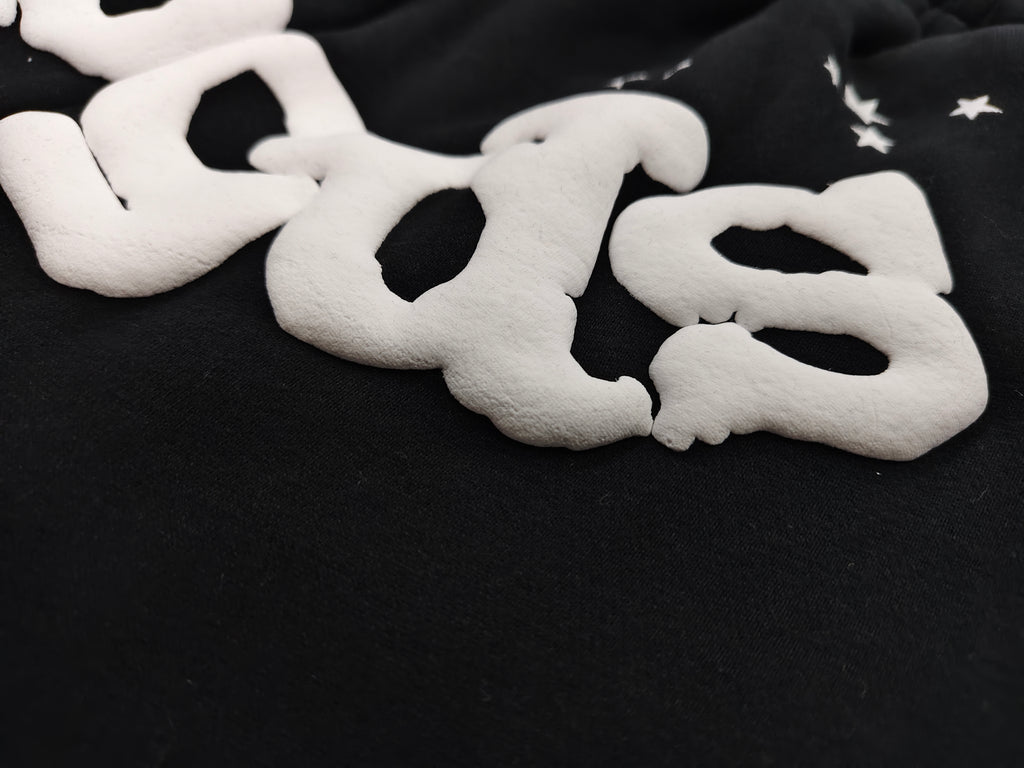 black Sp5der OG Web Logo sweatshorts featuring a prominent white puff-print logo and scattered star graphics