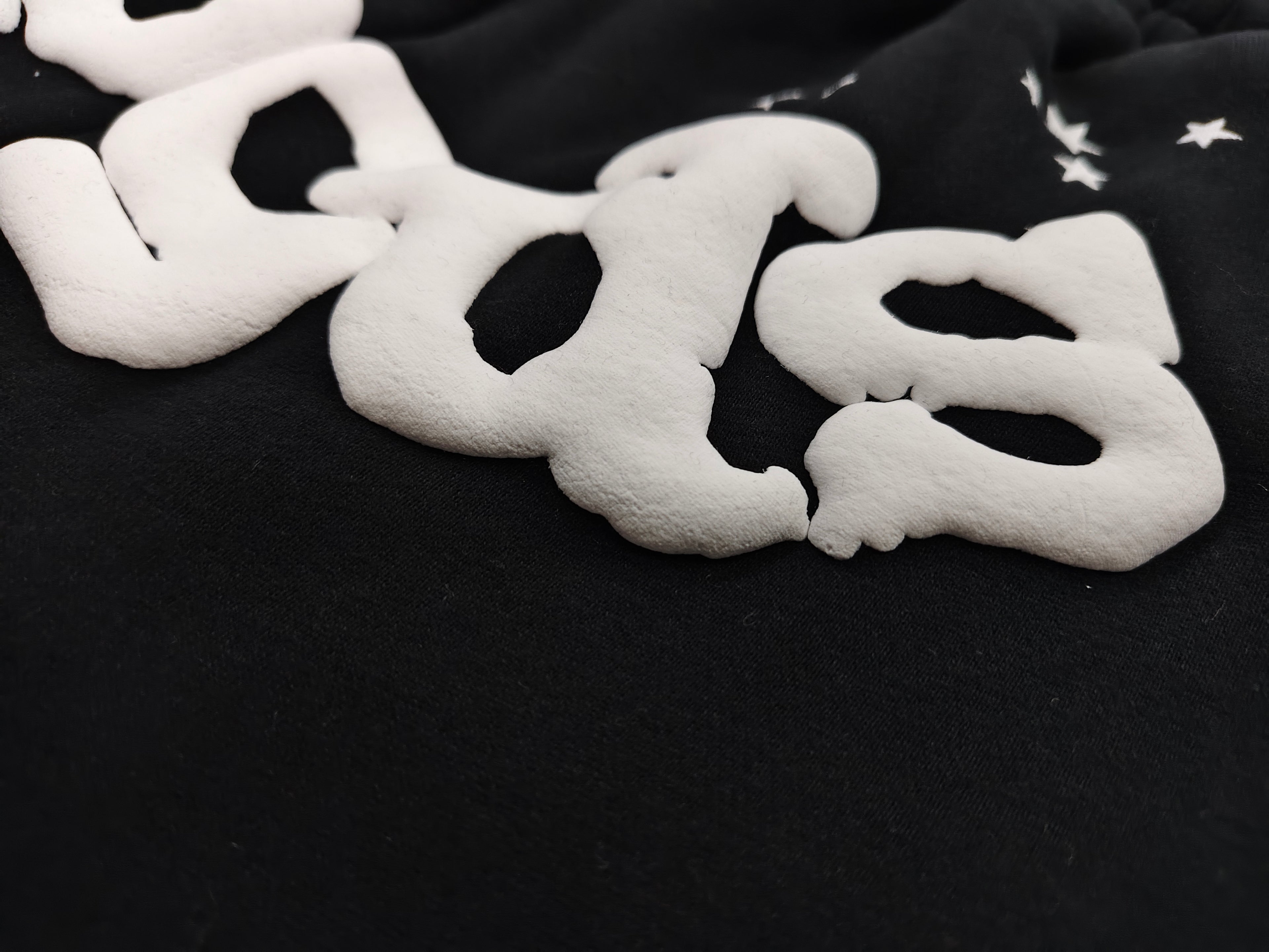 black Sp5der OG Web Logo sweatshorts featuring a prominent white puff-print logo and scattered star graphics