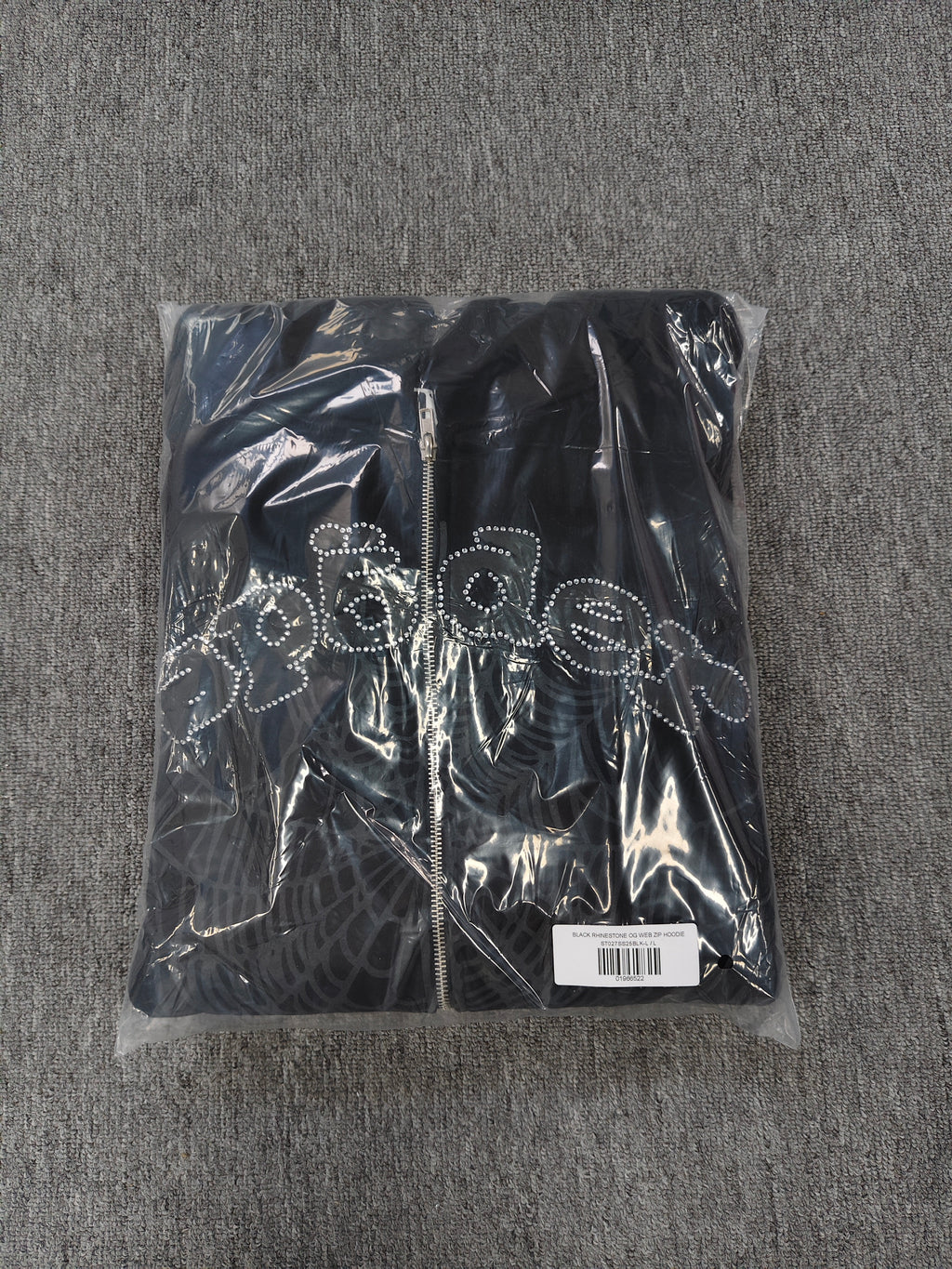 black Sp5der OG Web V2 Phantom Zip Up Hoodie features a prominent rhinestone-embellished logo and web graphic