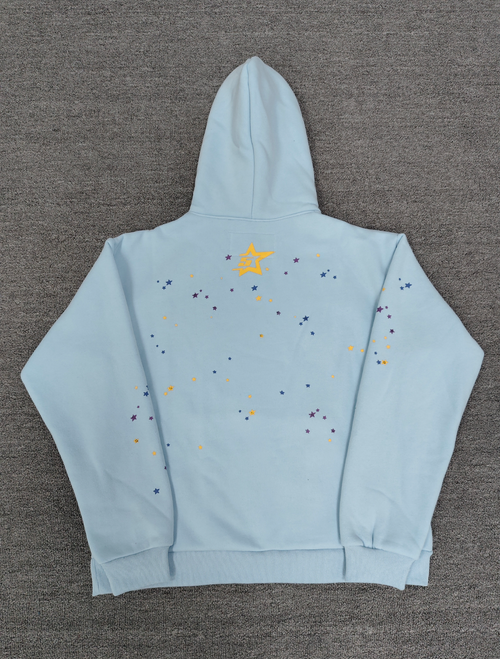a light blue Sp5der Worldwide hoodie featuring a prominent black graphic logo and a white spiderweb design filled with colorful stars