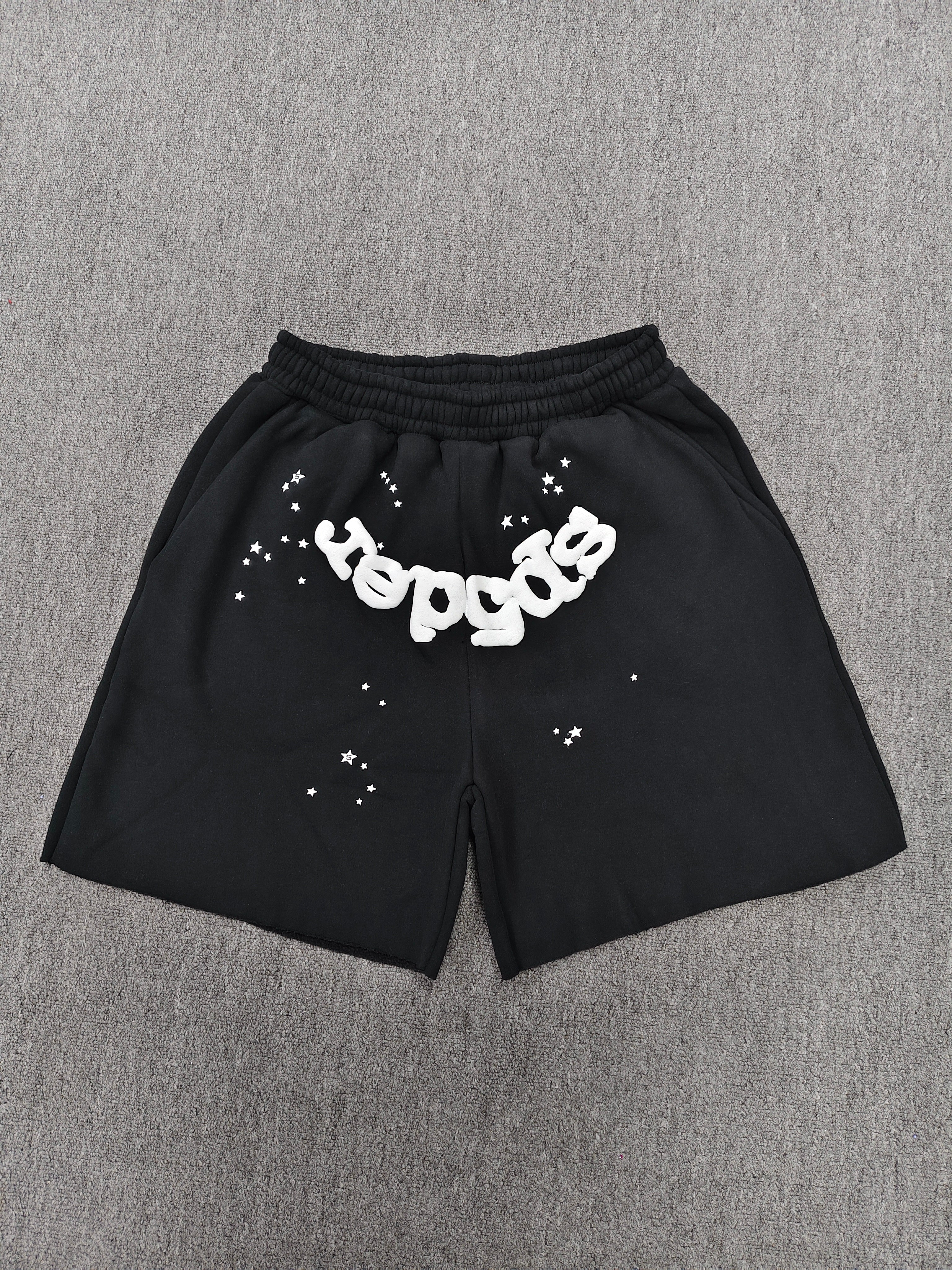black Sp5der OG Web Logo sweatshorts featuring a prominent white puff-print logo and scattered star graphics