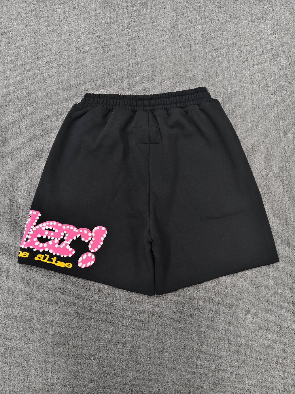 Sp5der Punk V2 shorts in black, featuring a vibrant pink logo and scattered colorful stars