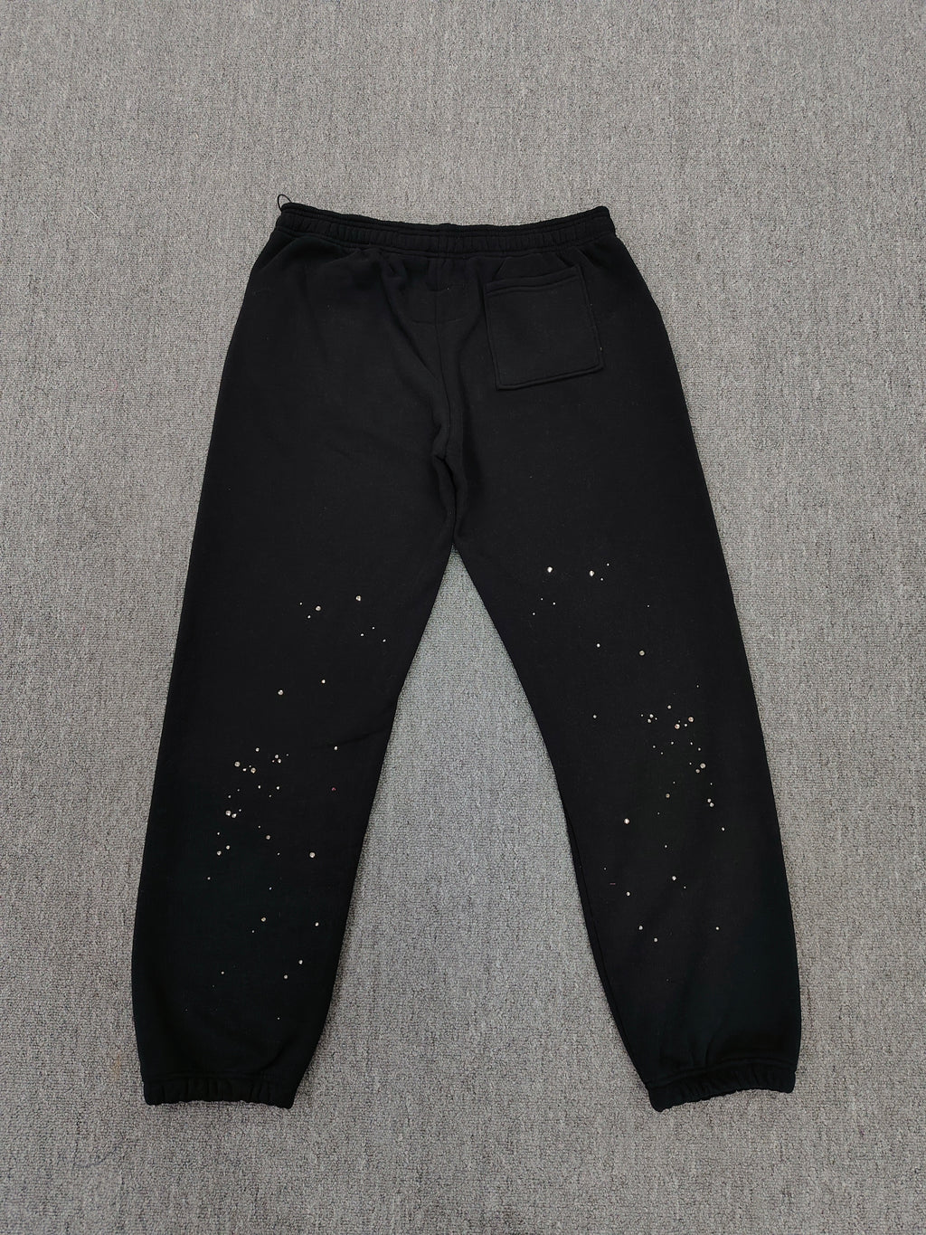 Sp5der Rhinestone Silk sweatpants in black featuring a large rhinestone-embellished logo and scattered star details