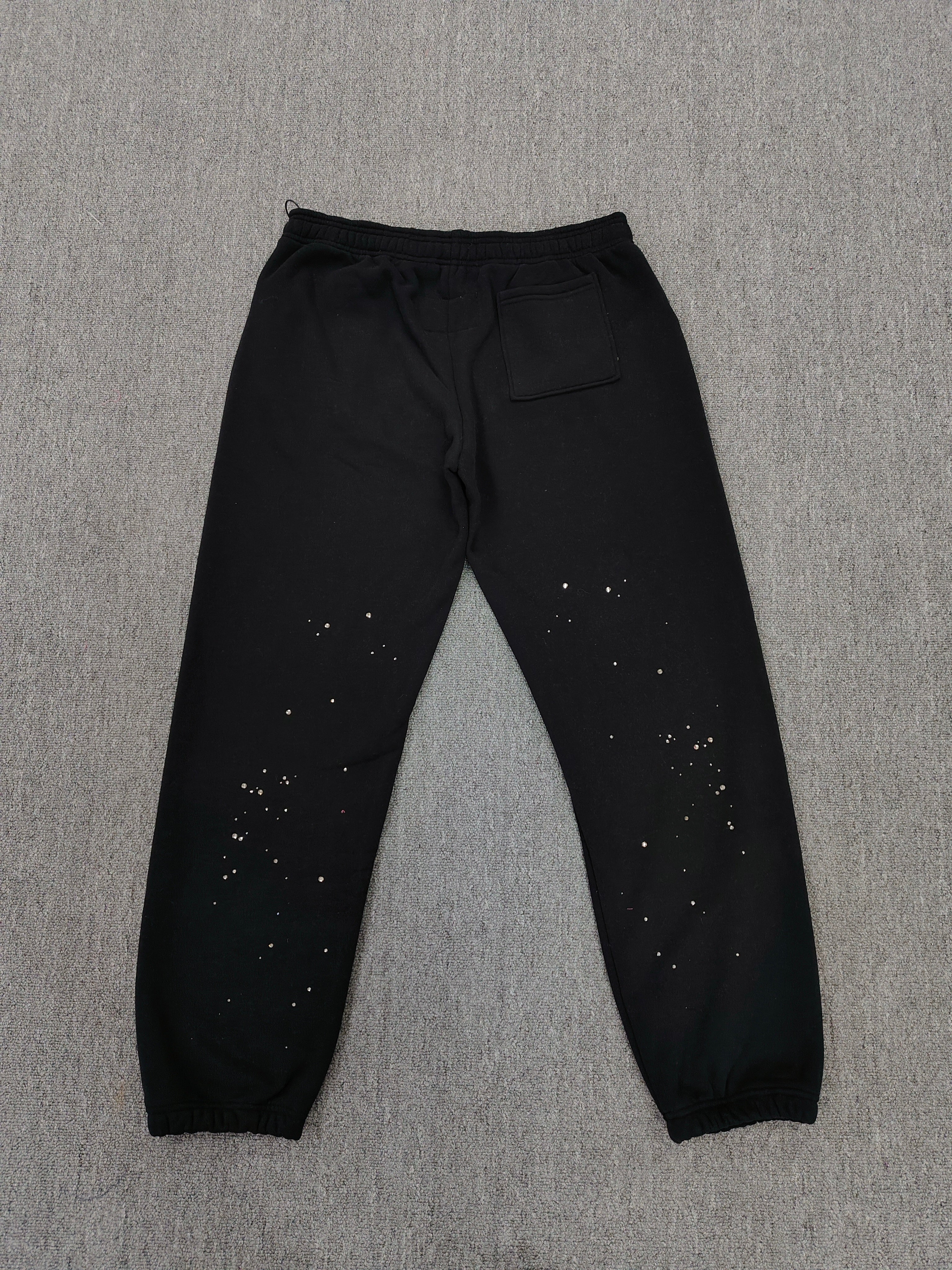 Sp5der Rhinestone Silk sweatpants in black featuring a large rhinestone-embellished logo and scattered star details