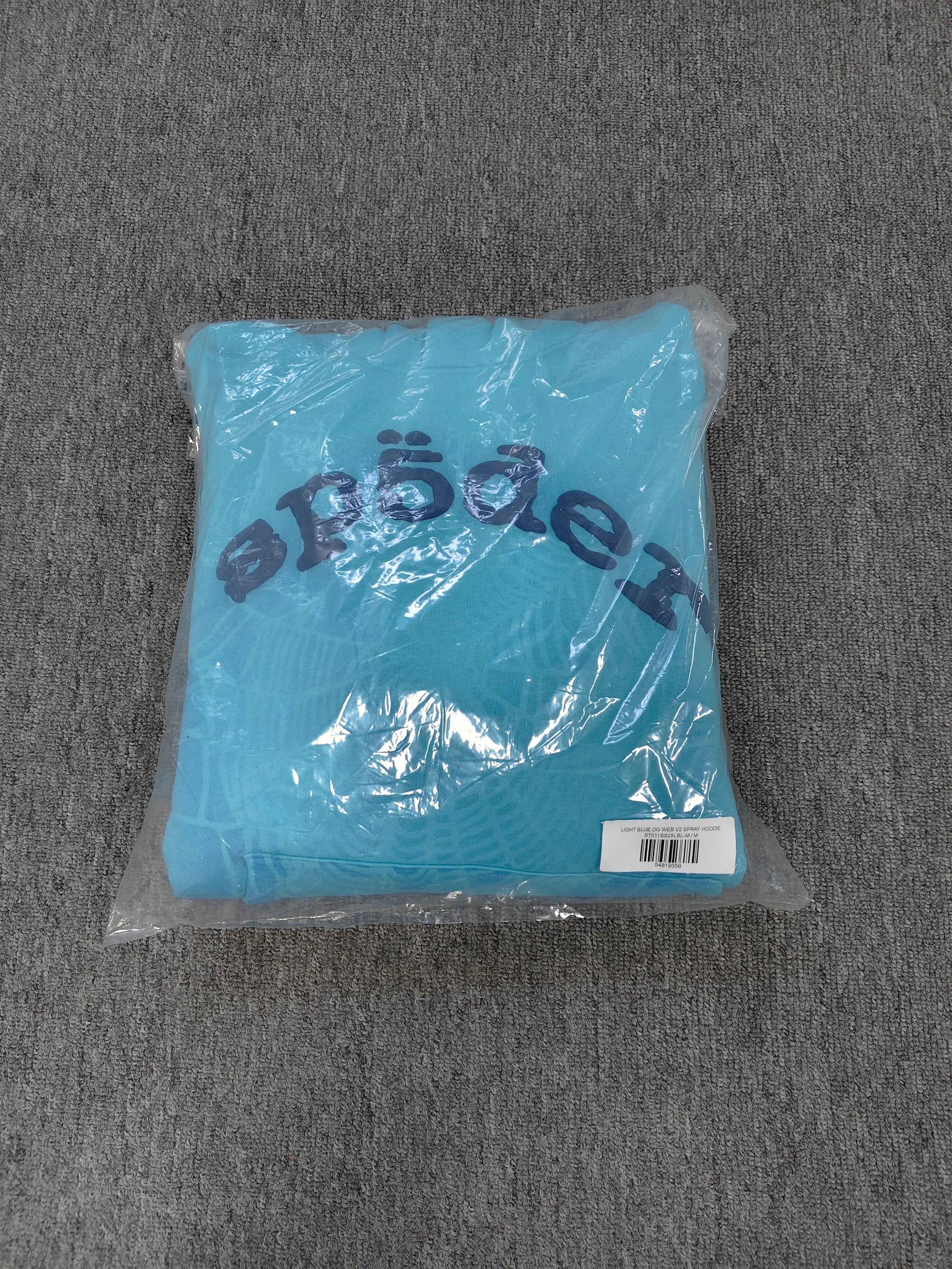 light blue Sp5der OG Web V2 Spray Hoodie features a prominent, sprayed-on navy spiderweb graphic
