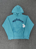 light blue Sp5der OG Web V2 Spray Hoodie features a prominent, sprayed-on navy spiderweb graphic