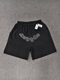 black Sp5der shorts feature a rhinestone-embellished logo and a spider web graphic