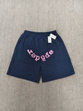 Sp5der jogger shorts are a navy blue color with a pink text graphic and rhinestone details
