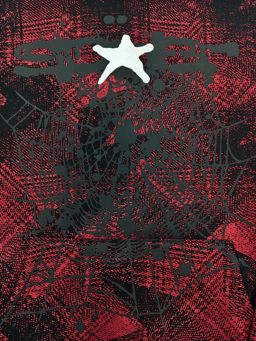 a Sp5der Plaid Splatt Hoodie in red, featuring a prominent white star graphic
