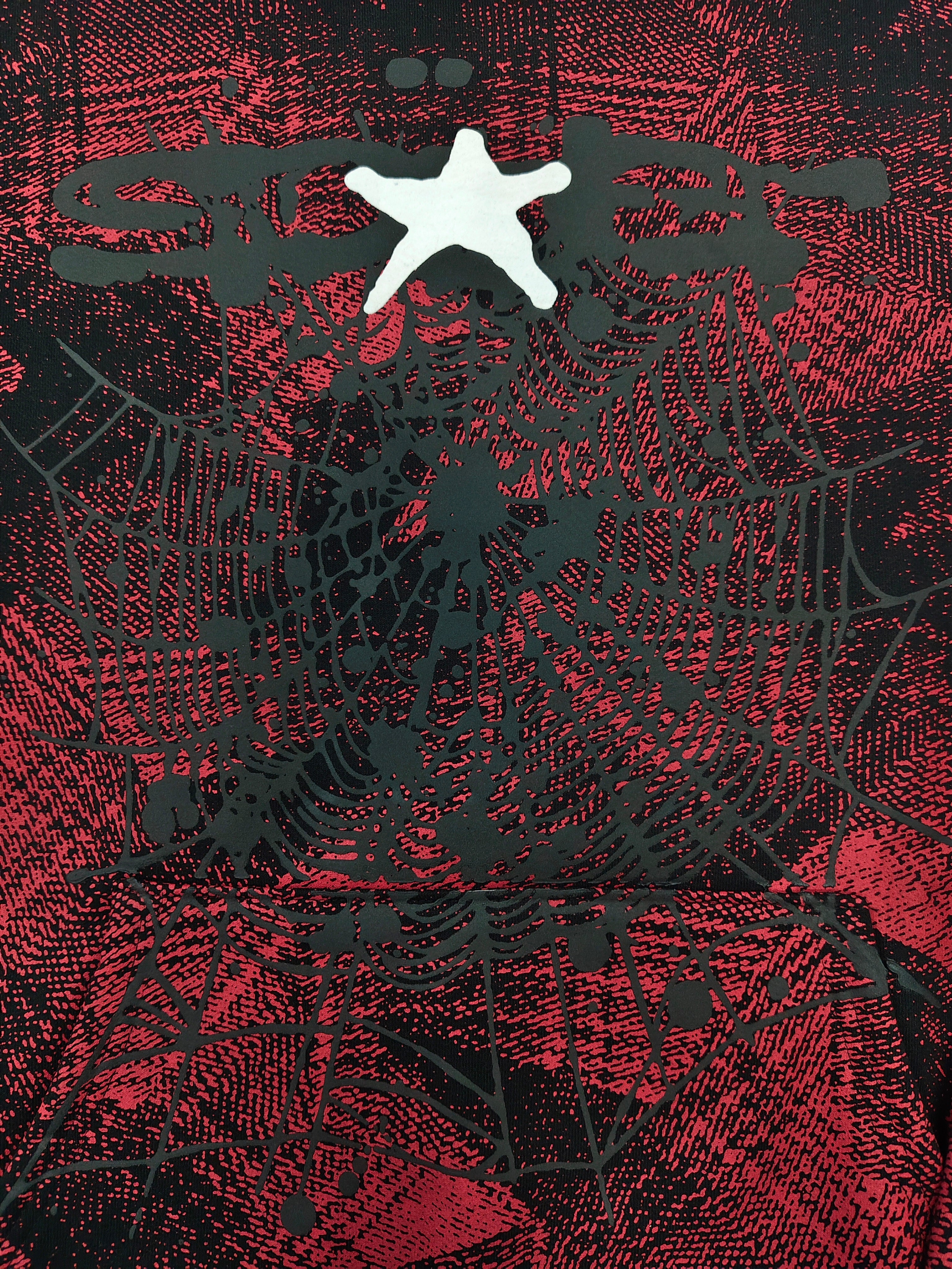 a Sp5der Plaid Splatt Hoodie in red, featuring a prominent white star graphic