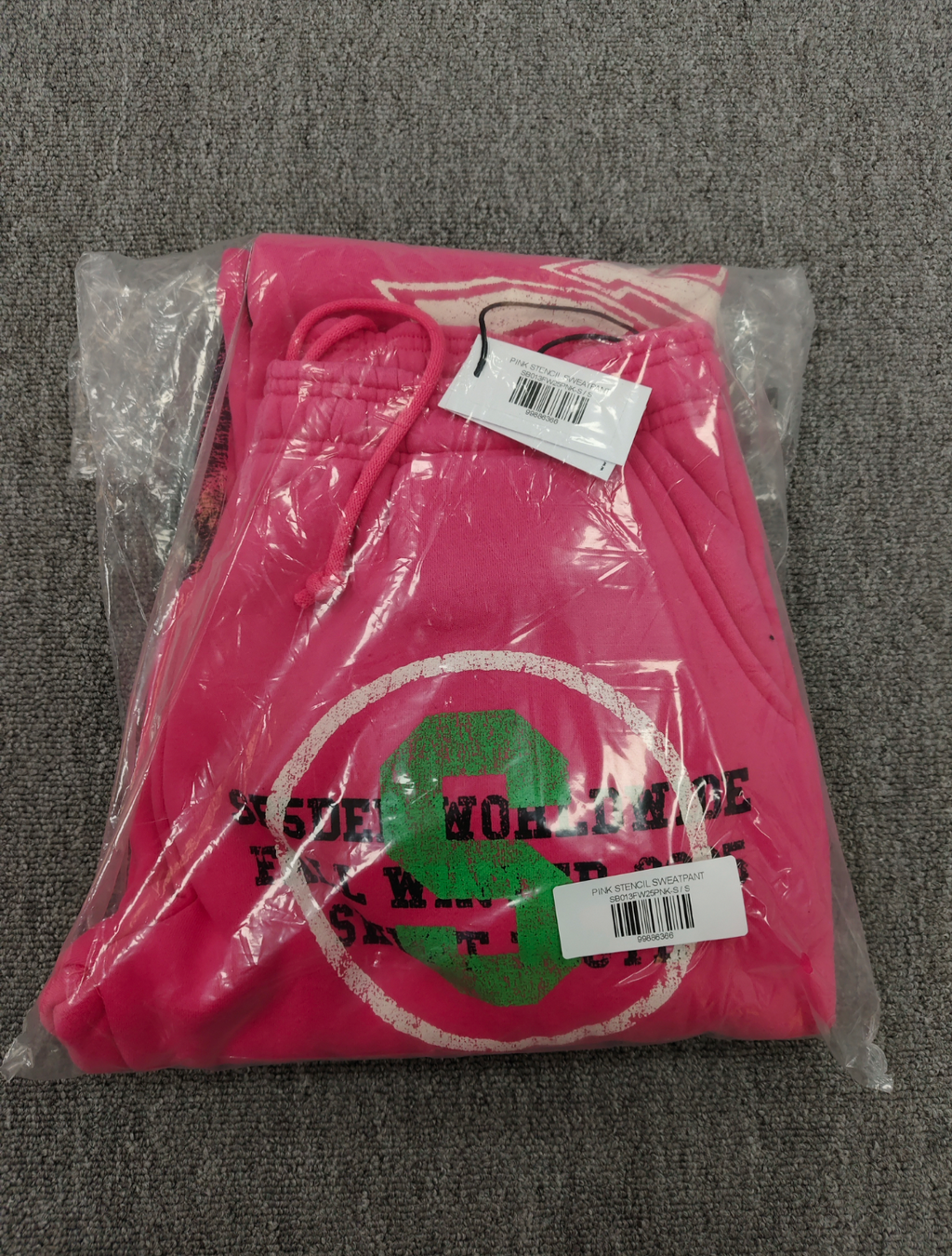 SP5DER Stencil Sweatpants in pink, featuring a large black star graphic on the left leg