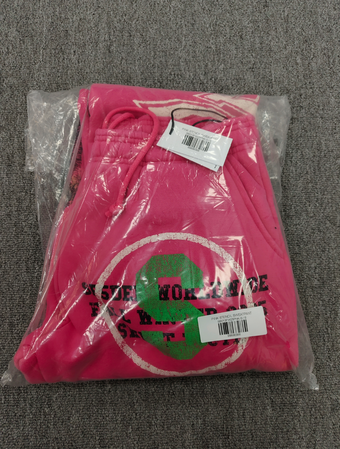 SP5DER Stencil Sweatpants in pink, featuring a large black star graphic on the left leg