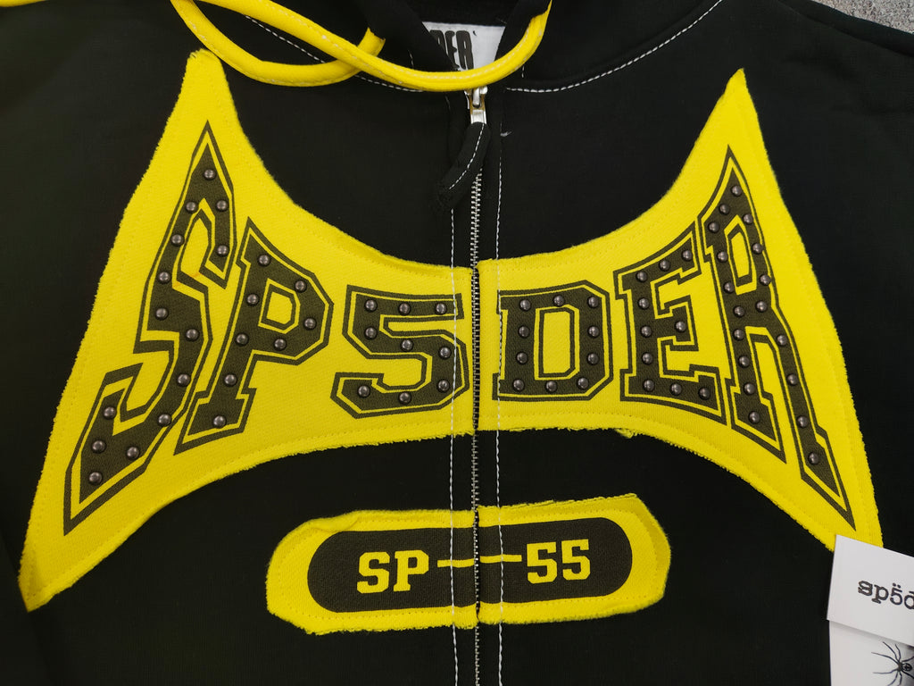 a Sp5der T&F Zip Hoodie in black and yellow with contrast stitching