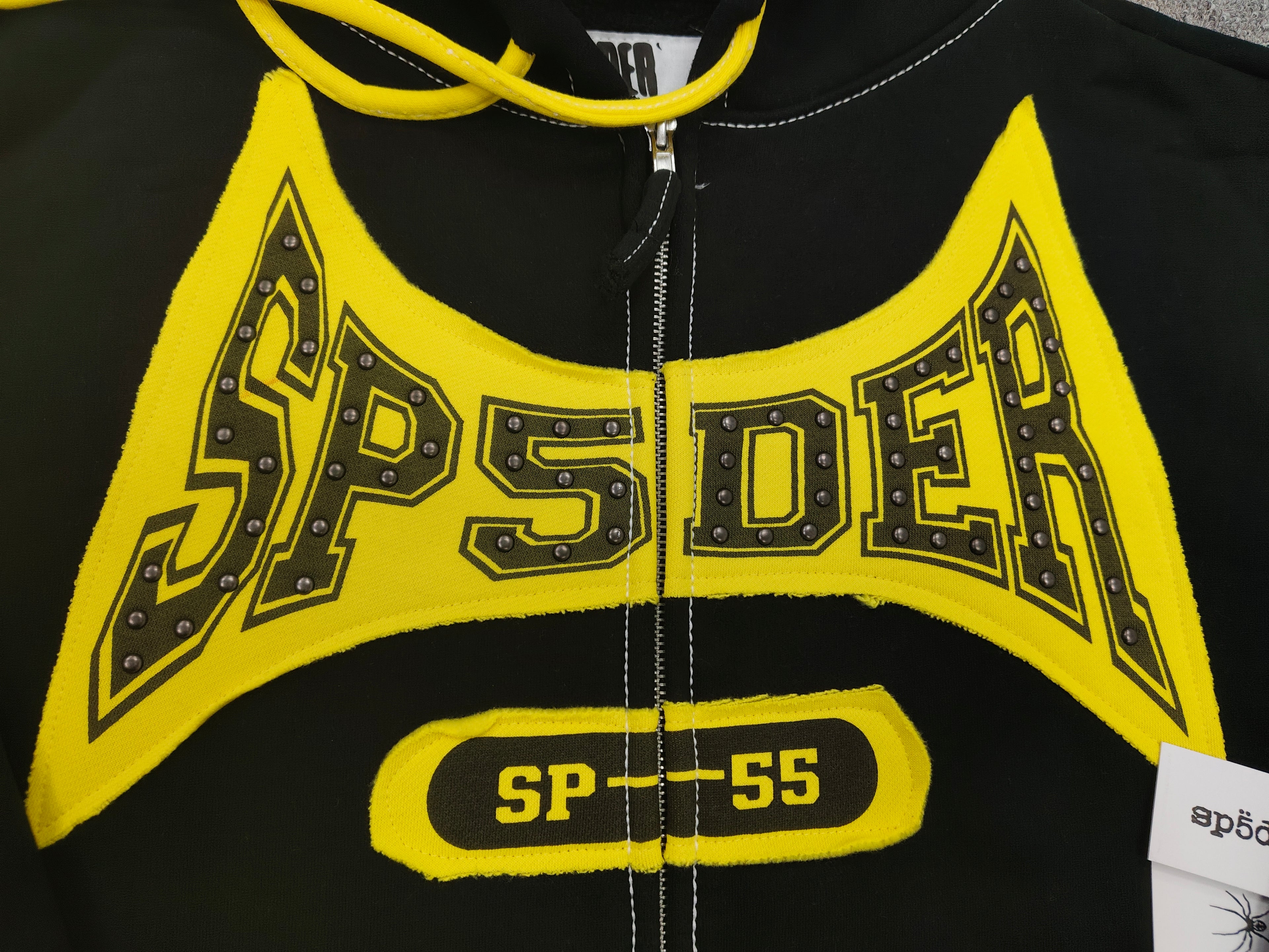 a Sp5der T&F Zip Hoodie in black and yellow with contrast stitching