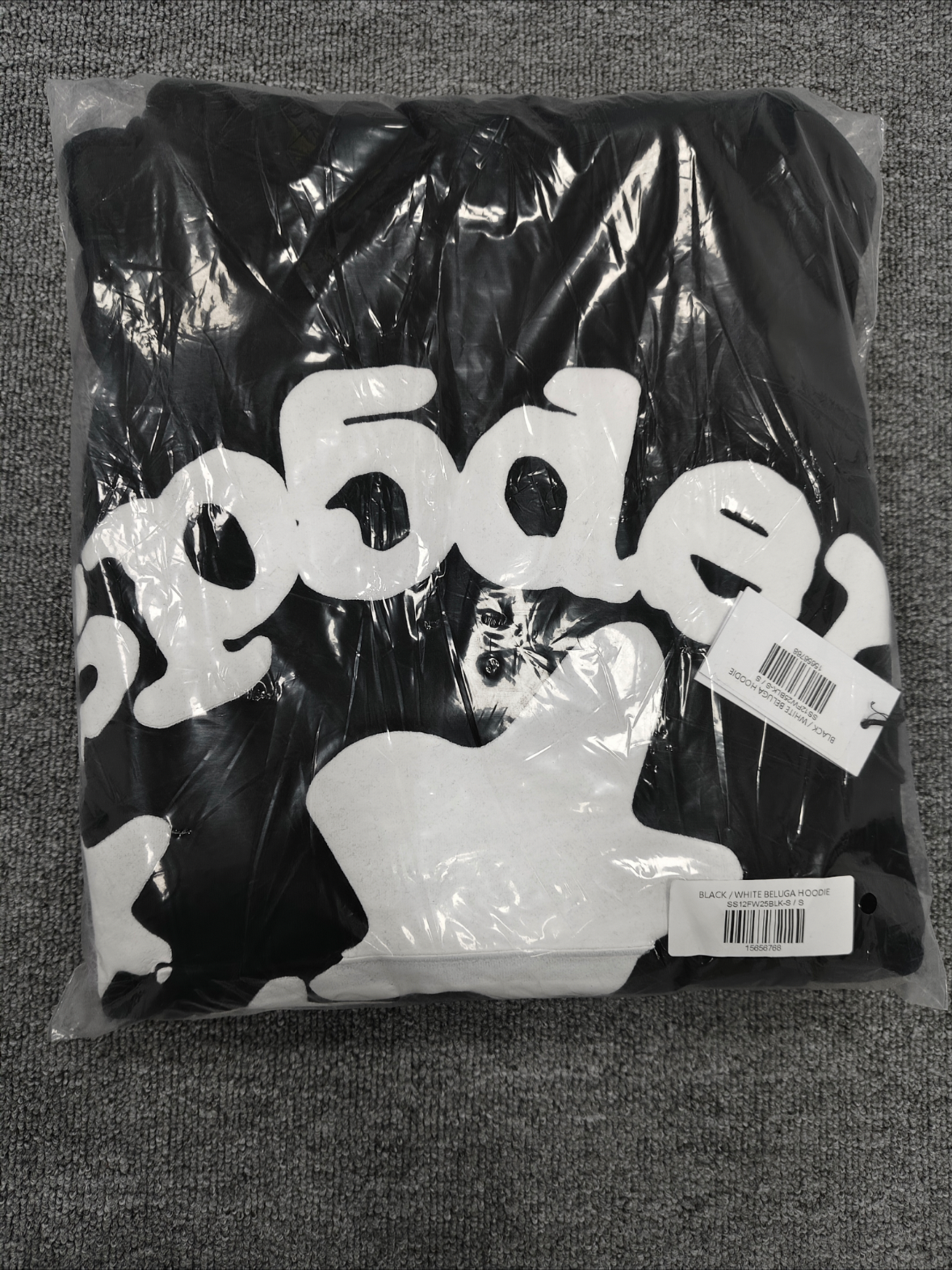 black Sp5der hoodie features reflective white graphic prints of the brand name and stars