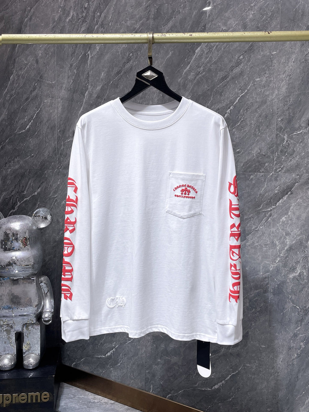 a Chrome Hearts Hollywood Triple Cross Long Sleeve T-Shirt featuring a prominent graphic on the back.